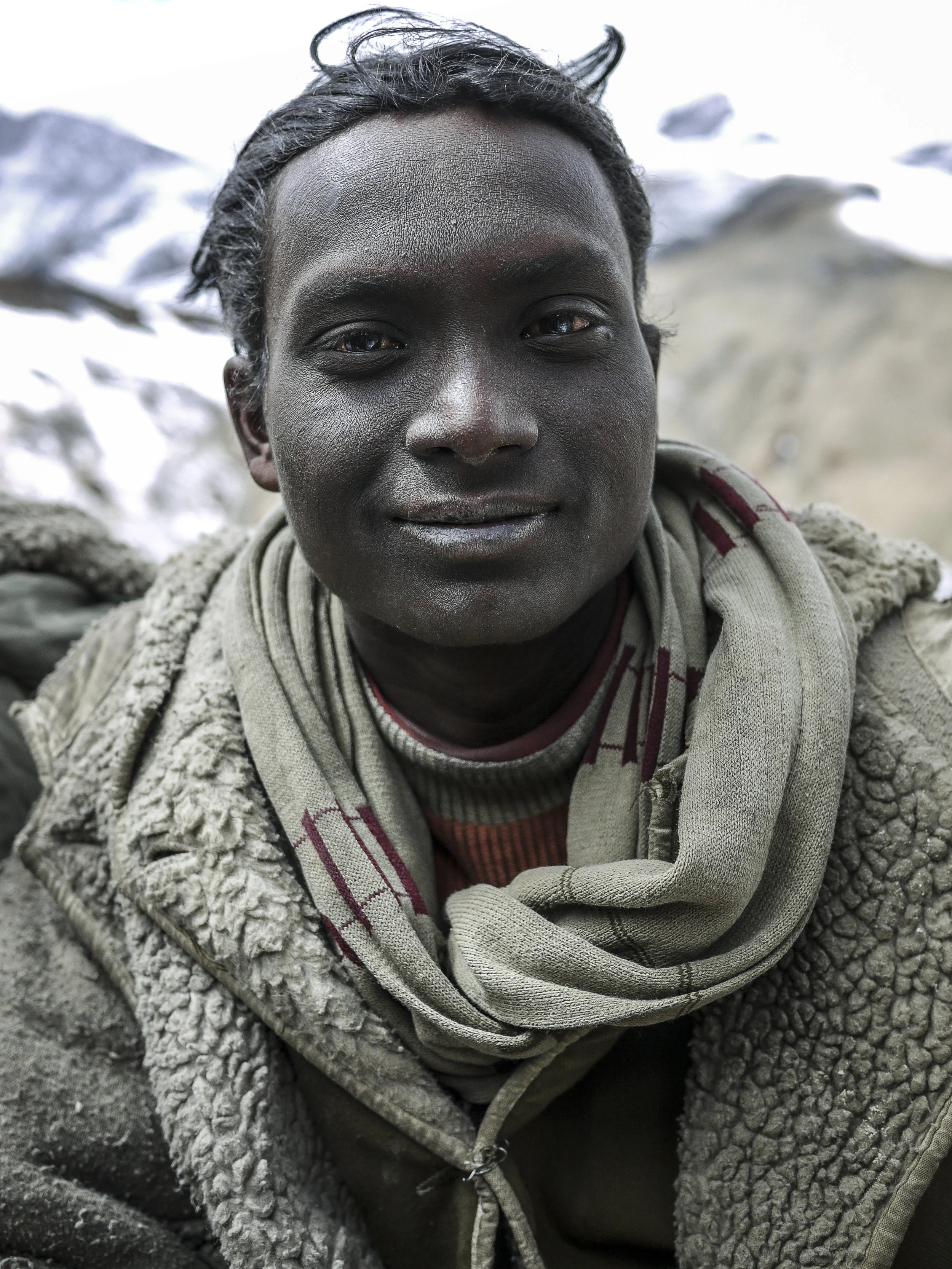 A young Bihari man with unusual coloured eyes. The effects of the high-altitude conditions are apparent on his face.