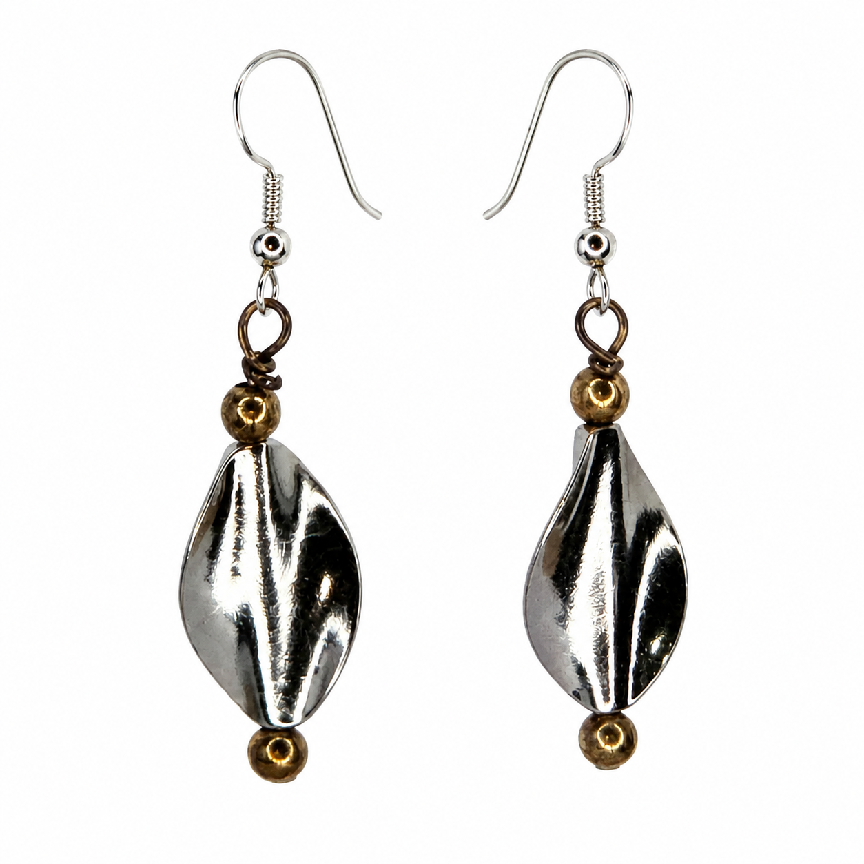 Pair of handmade silver-tone leaf drop earrings with warm metallic accents on a light neutral background.