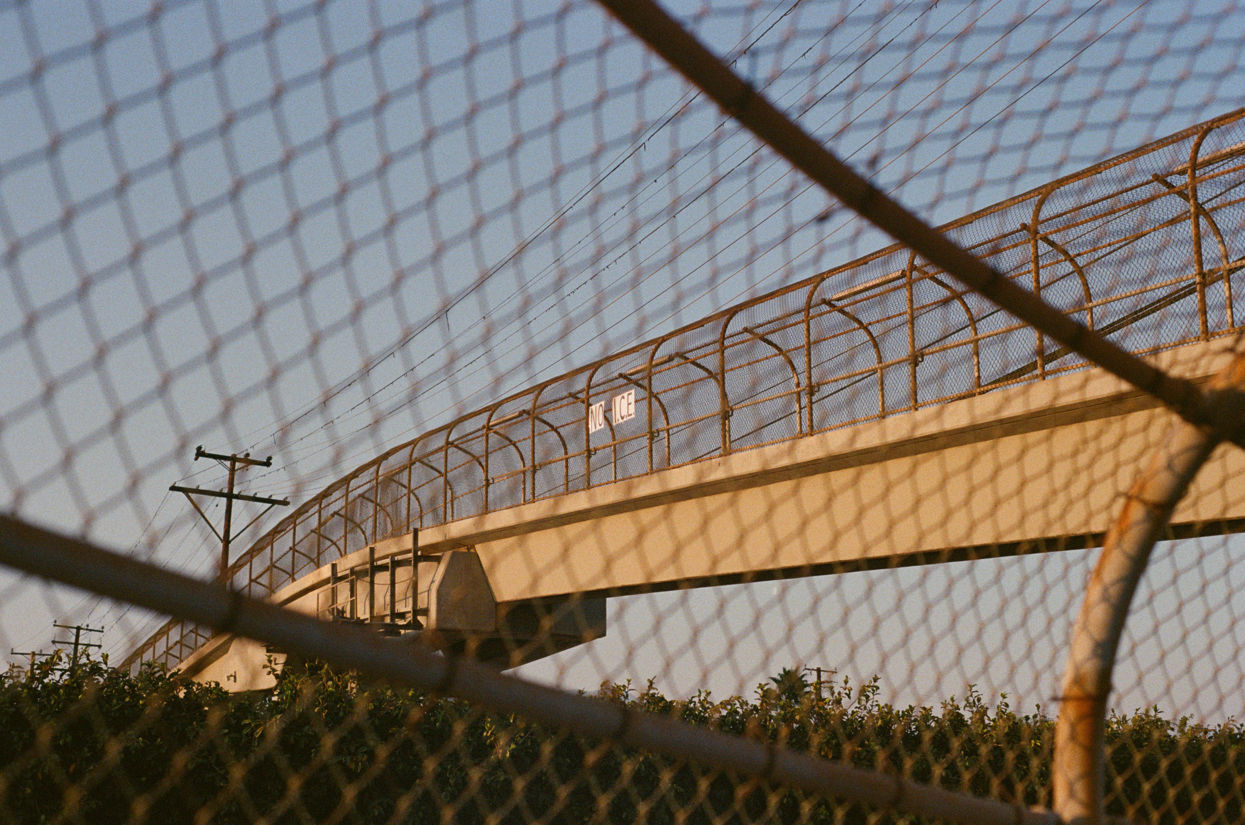 a bridge above the freeway in alhambra, ca, or, under the sky of the los angeles area. 2016. there are many signs on these bridges, besides "no i.c.e.," people have also hanged up "no wars" etc. 