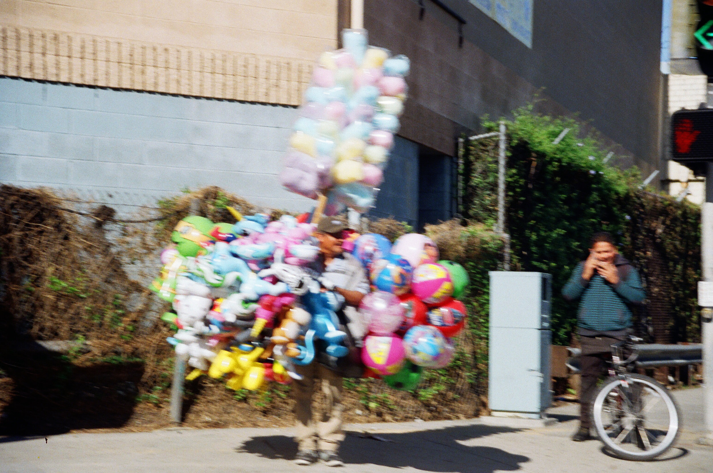 many of them sell balloons next to the entrance of freeways. they stand in the same spot for hours as cars drive by but never stop. los angeles, 2017