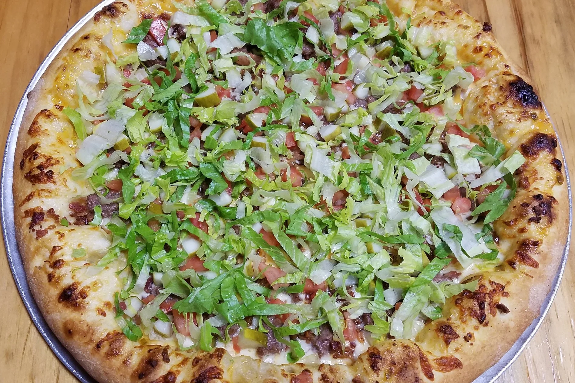 The Mac 1000 Island, Cheese, hamburger, bacon, pickles, lettuce, tomatoes S 9.50 L 18.99