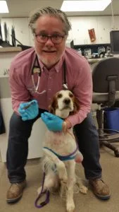 Dr. Andrew Jackson of BluePearl Veterinary Partners with the stick he removed from Cuddy.