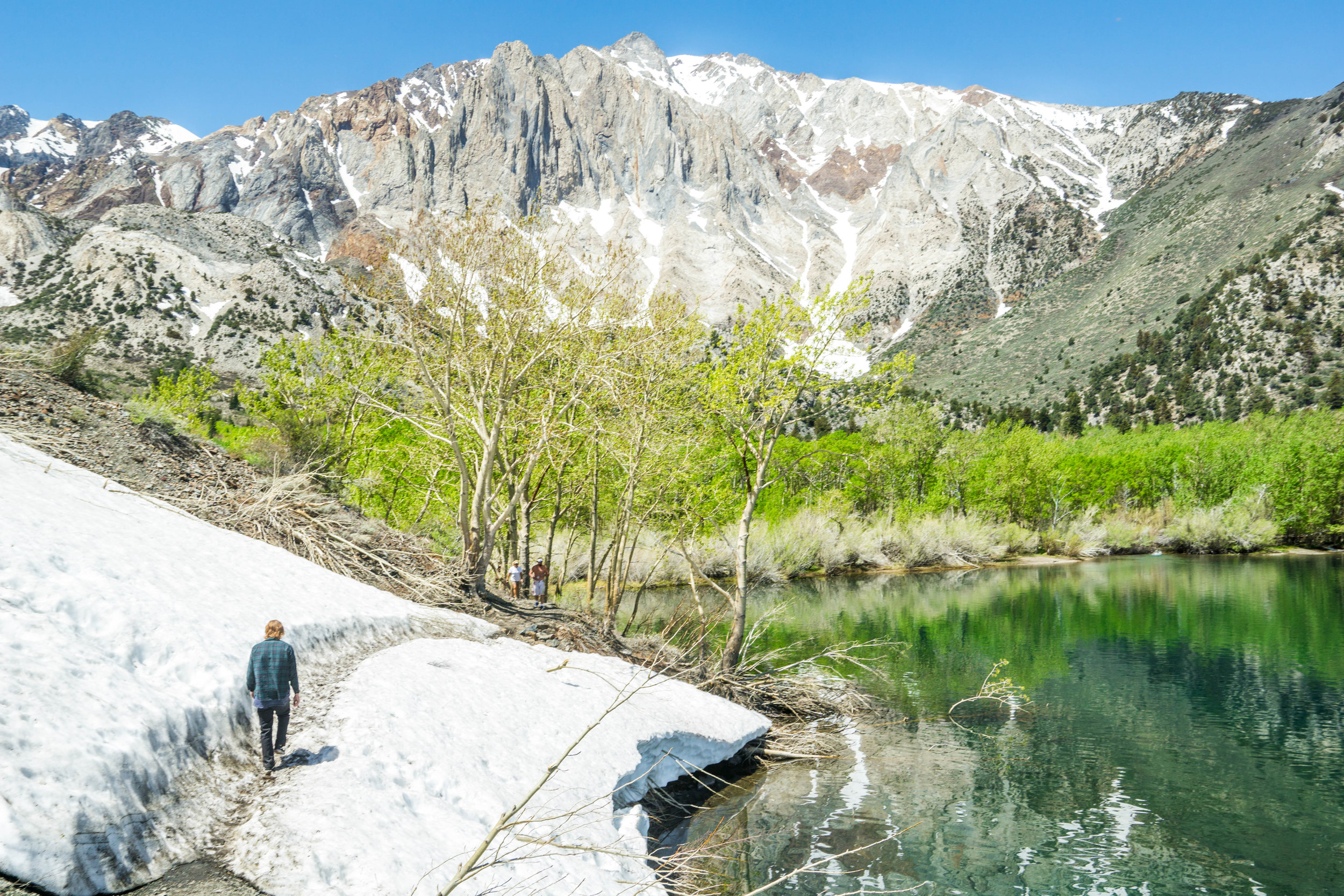 Even in late Spring & early Summer, there is frequently snow on the trail in the Sierra Nevadas. Walking without traction, we methodically crossed to assure we didn't slip & slide into the lake.