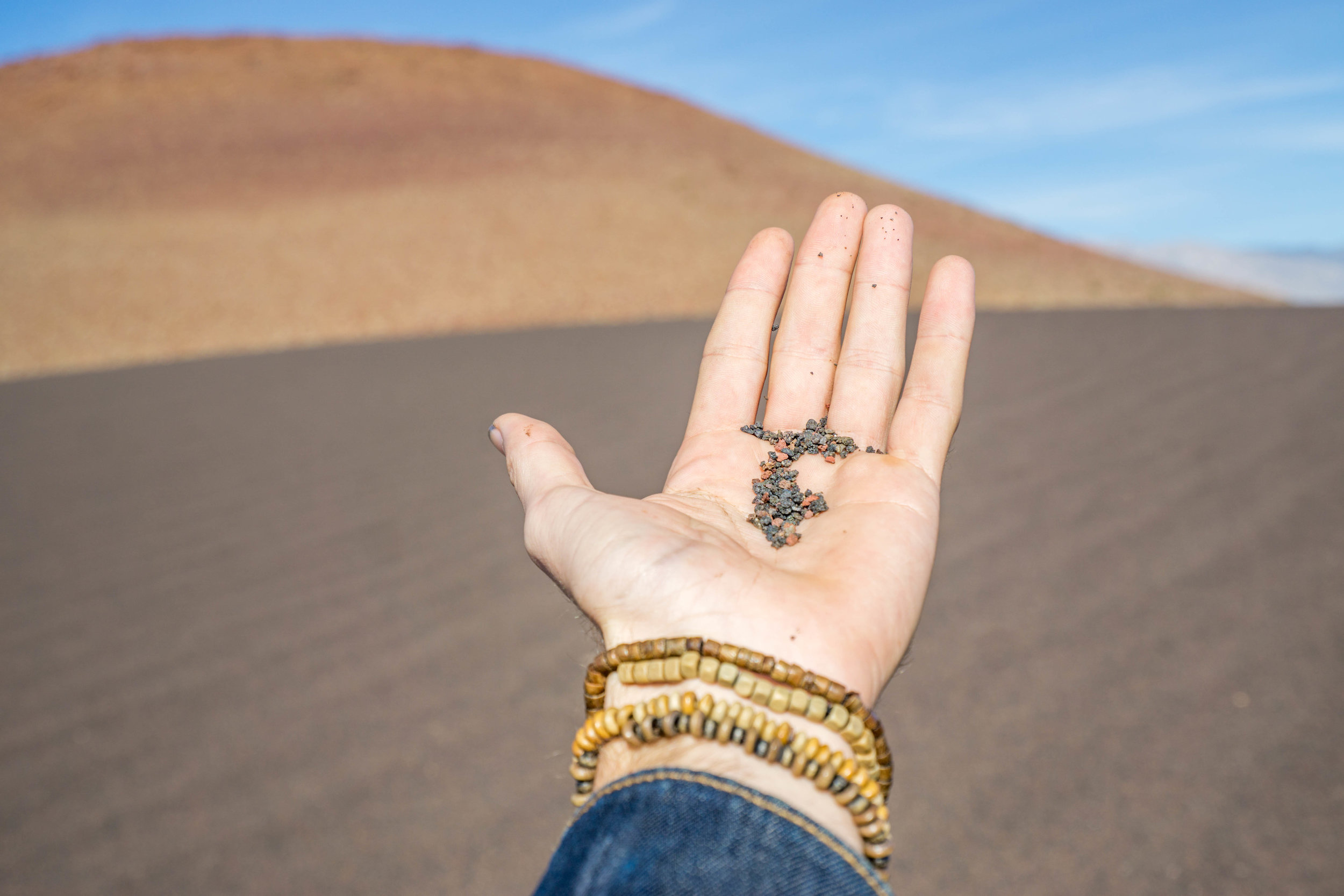 A mixture of red &amp; black volcanic sand forms a small series of desert dunes.