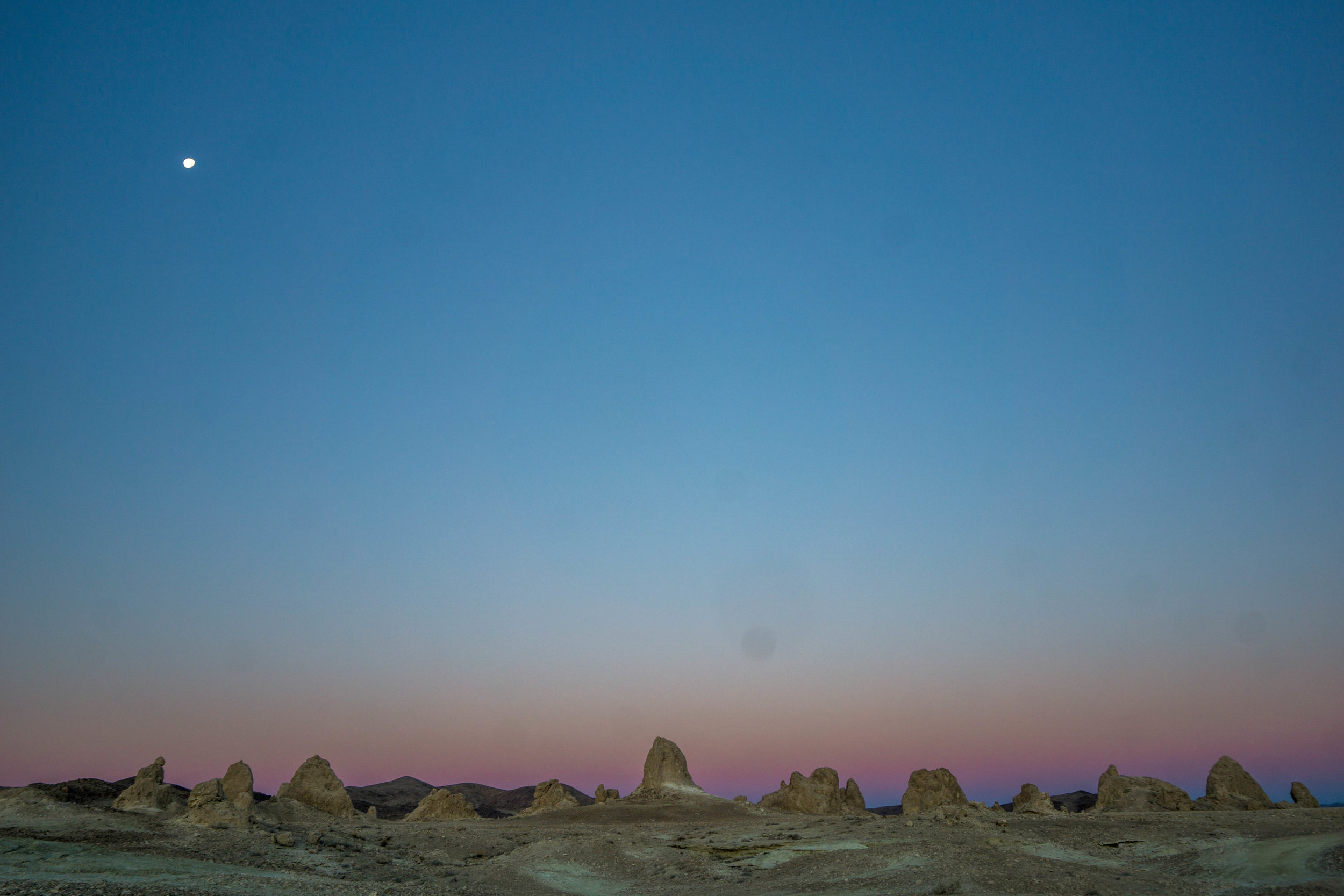 Pre-sunrise creates an alien world. A soft pink band hugs the skyline of ancient sea towers. 