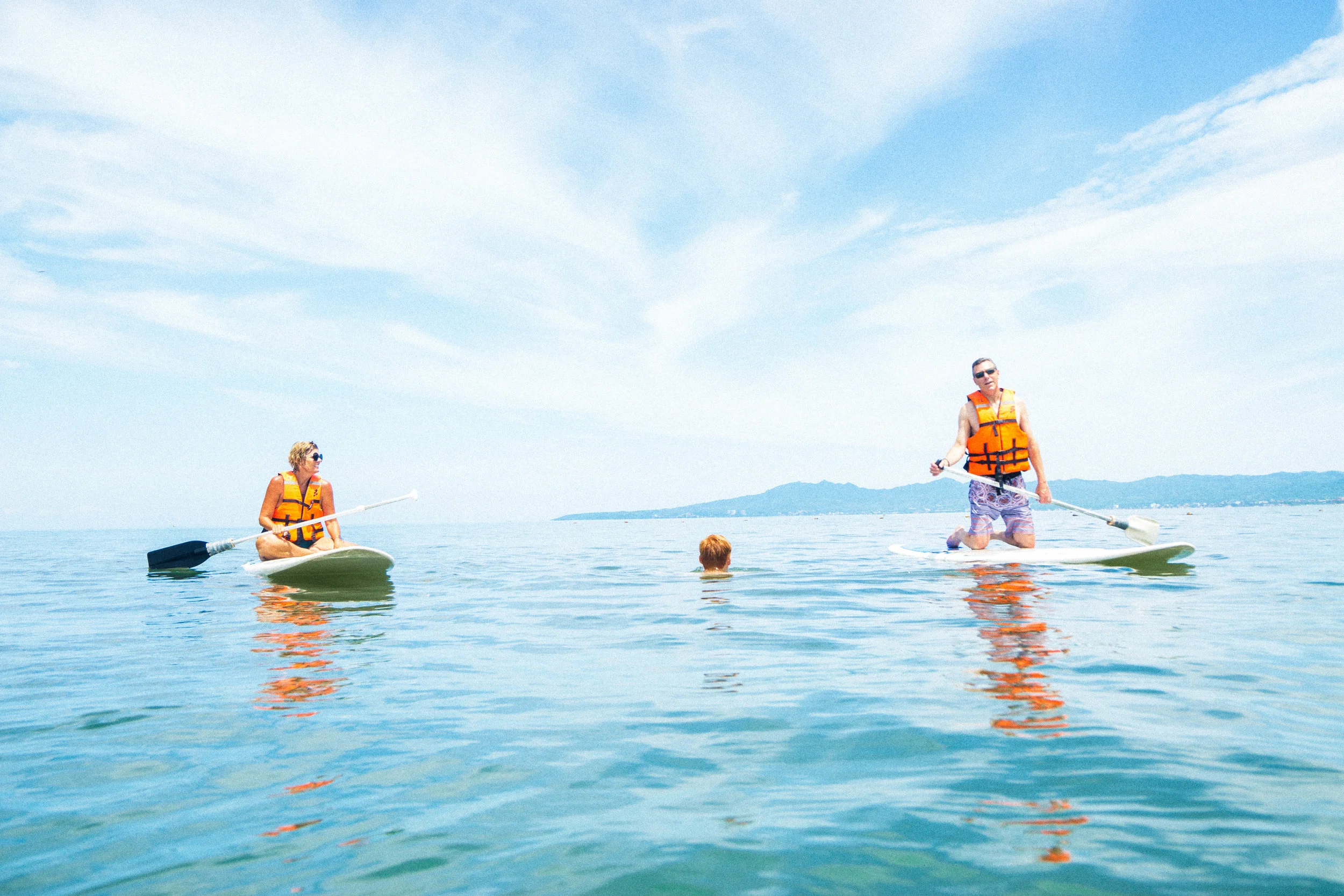 The next day the whole family swims &amp; paddleboards in between games of volleyball. Over the years we've bonded over trips just like this.