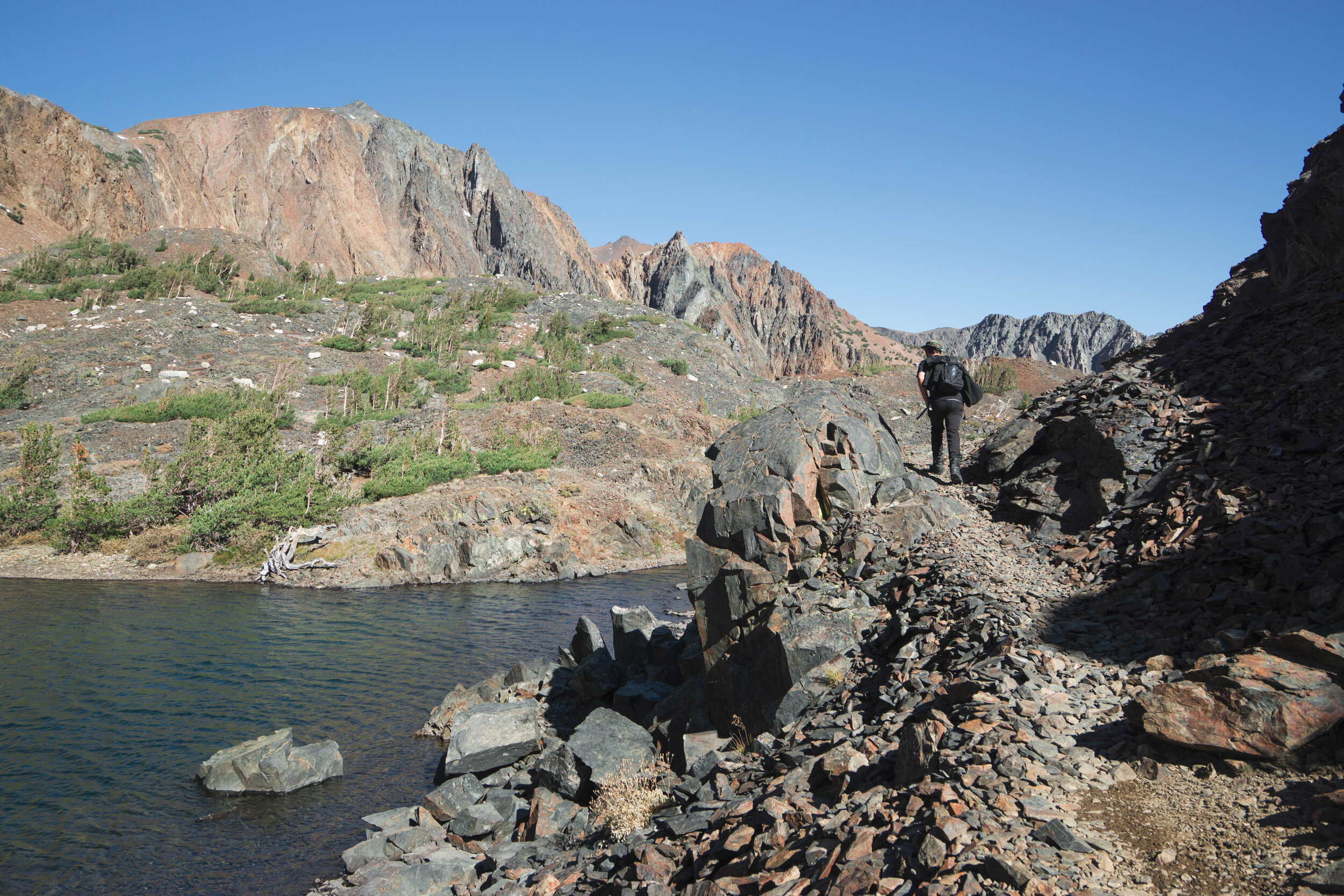 The shale lined shore's irregular rocky flakes jostled beneath our feet, refusing to give us secure footing.