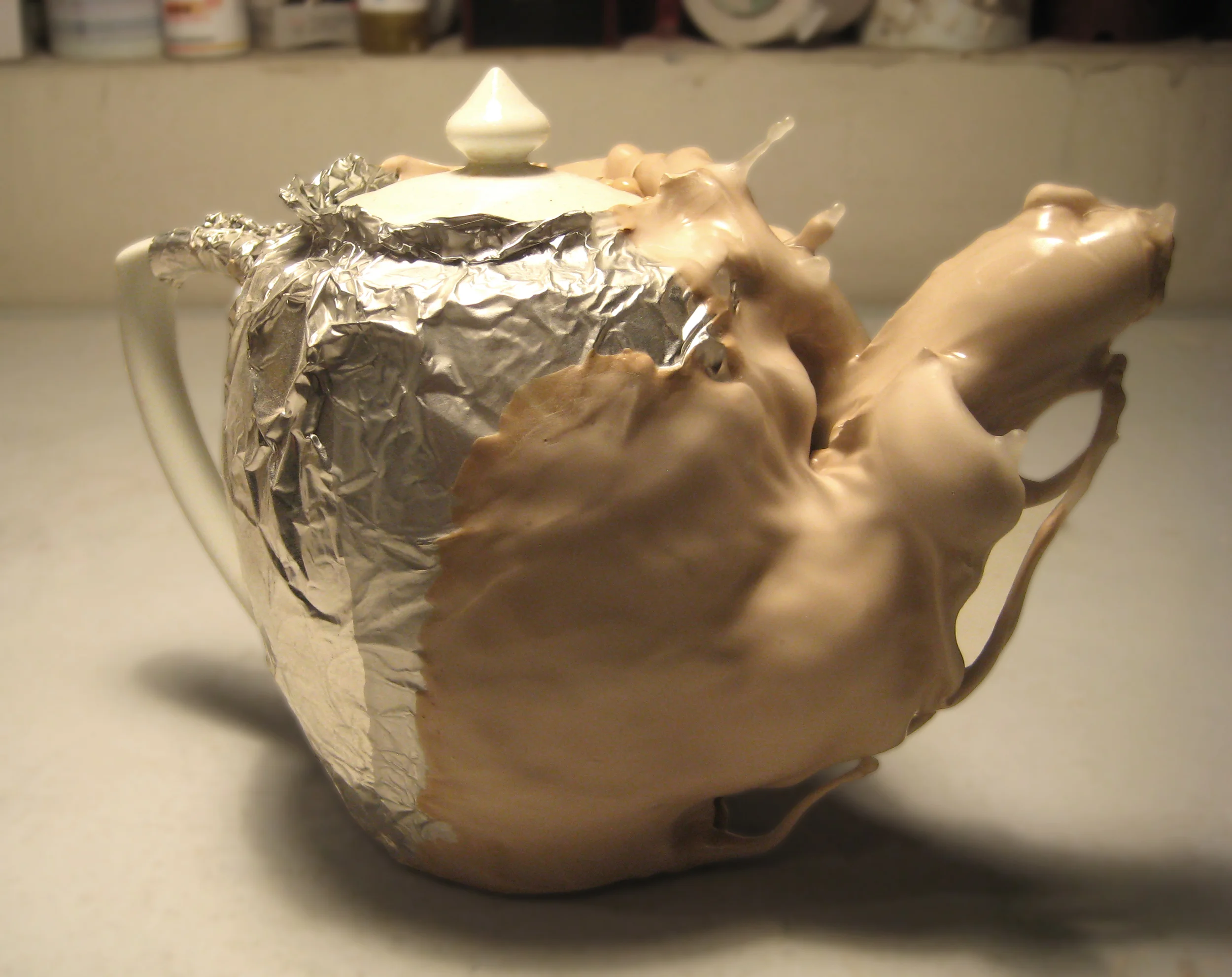 Found objects, casting slip, aluminum foil, wax