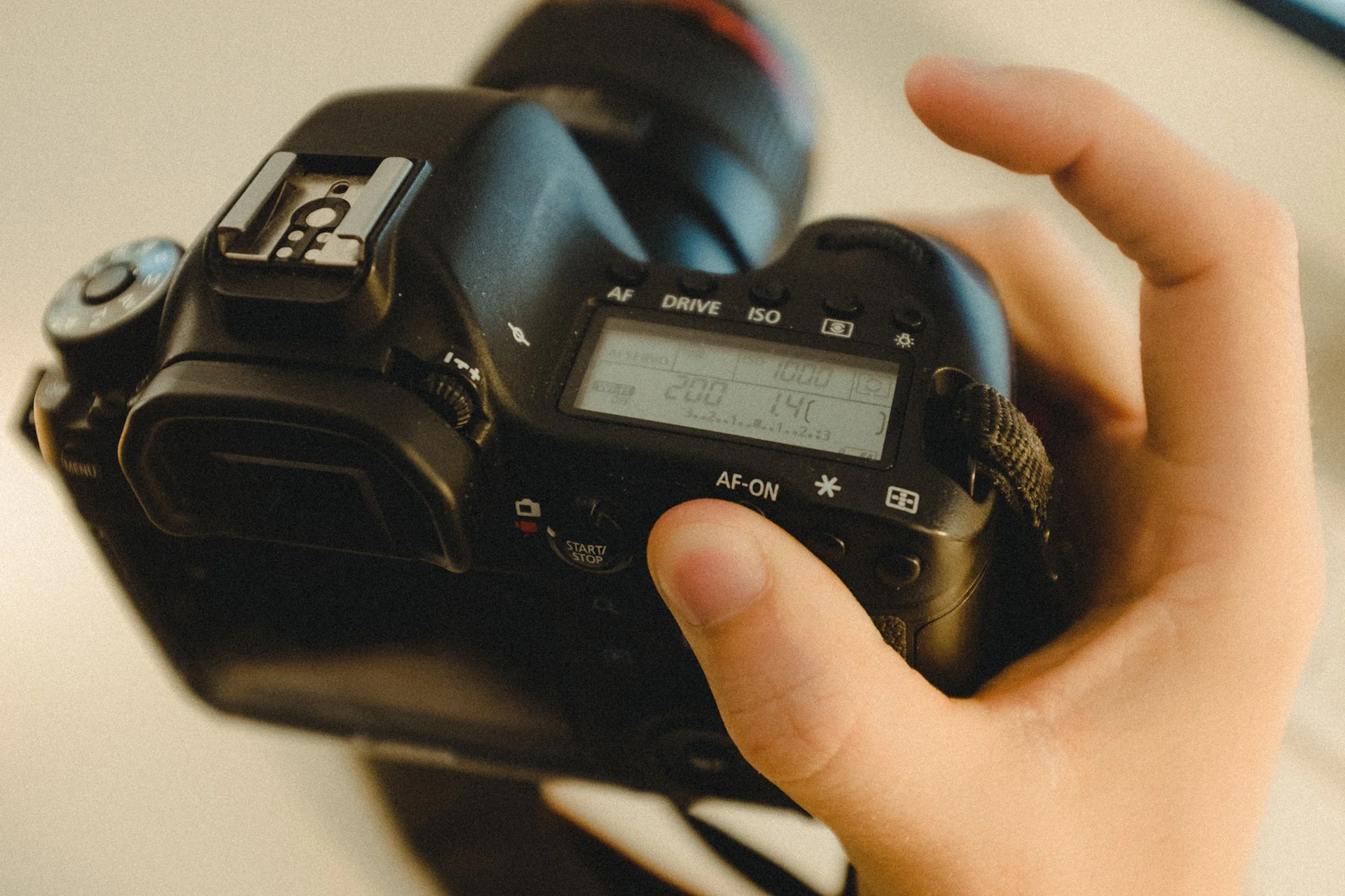 Use your thumb on the AF-ON button to focus.