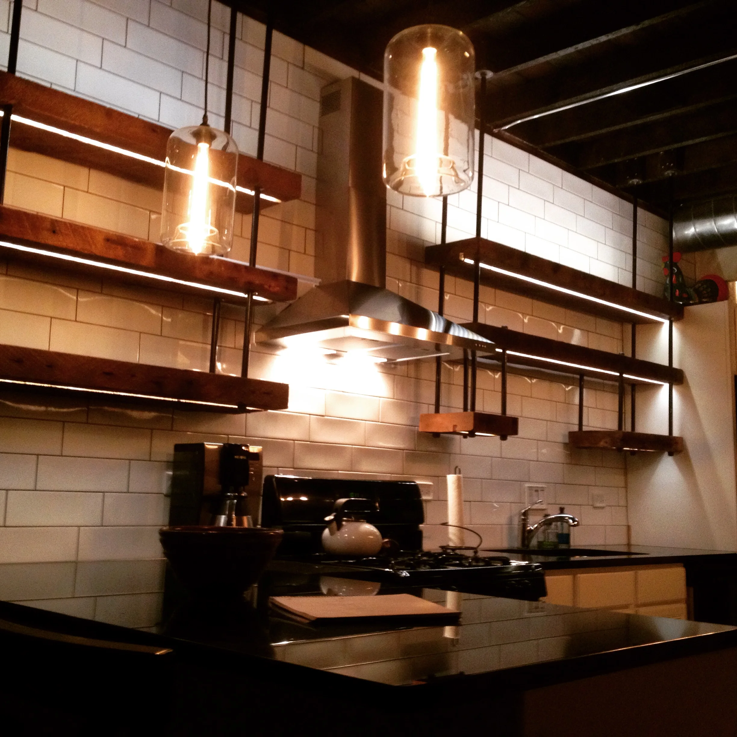 Custom Industrial Pipe Shelves with Cove Lighting