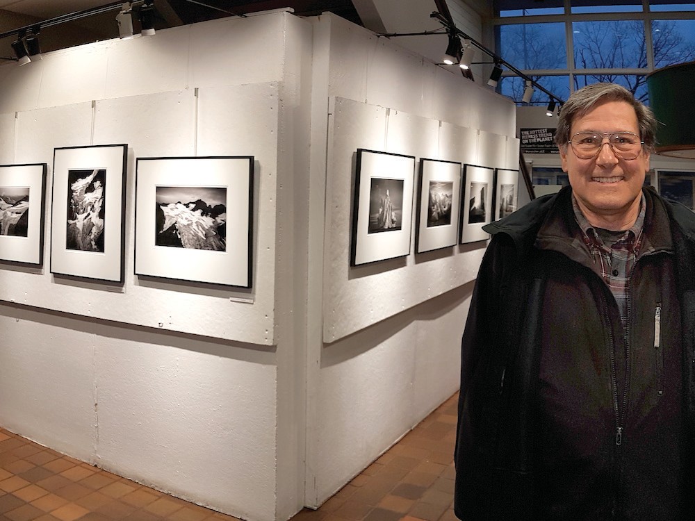 Ron Rosenstock in front of his exhibition at the Worcester JCC on Salisbury St.