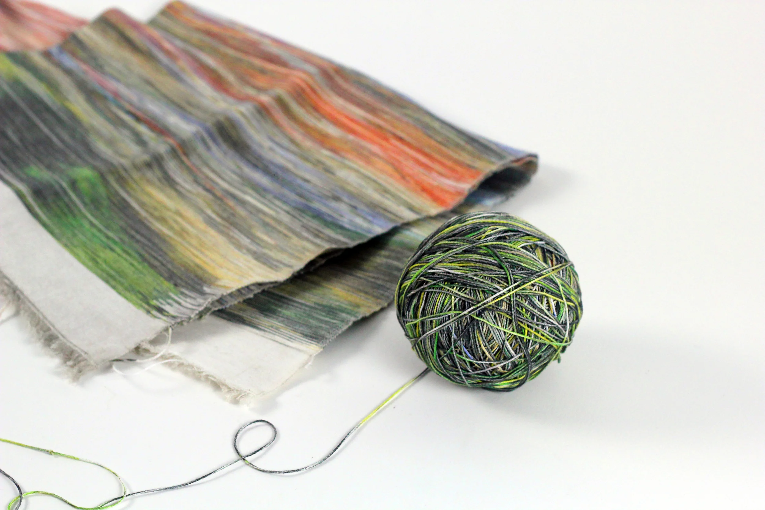 photograph unravelled in a ball of yarn next to rewoven textile