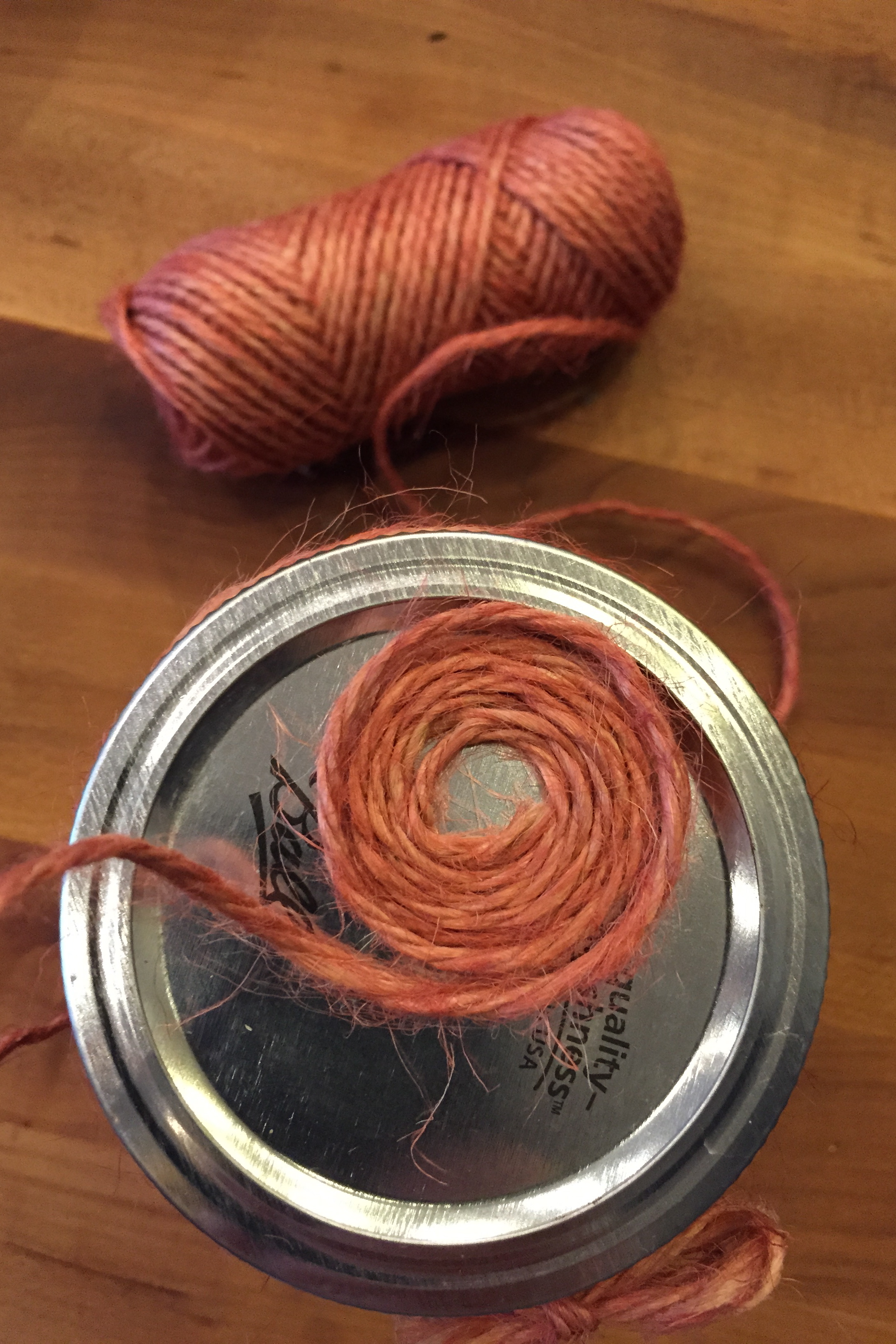 1. Spiral the twine. Leave space in the middle and don't use glue yet. Just spiral and secure with your fingers until you cover the whole lid.