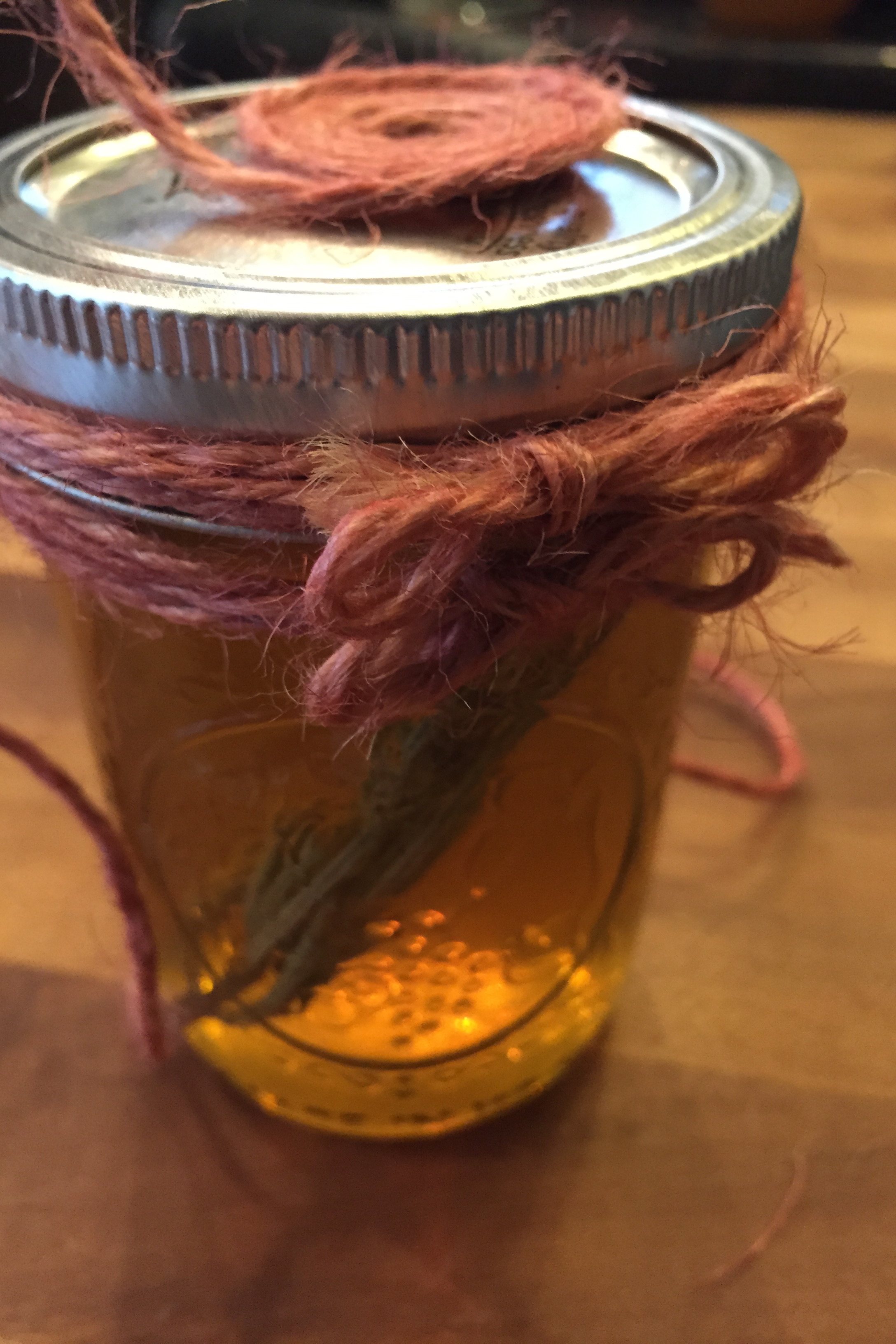 After you tie the twine bows around the jar, then work on the top. This will make designing the top easier. Fill in any gaps by wrapping more twine around the jar and knot.