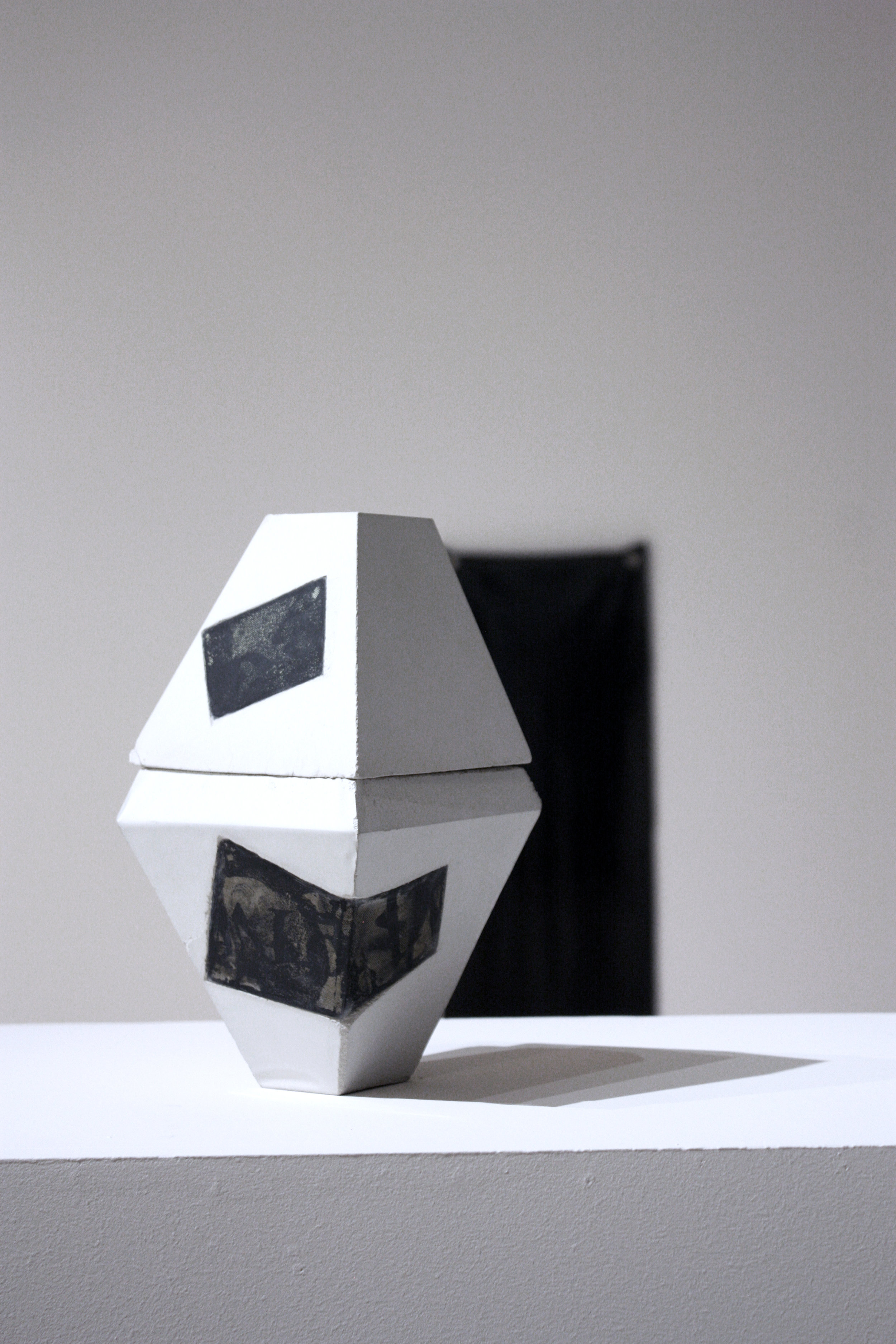 “A” on top of “I will”. Cement and silkscreen on latex. 12 x 5 x 5 inches. 2016