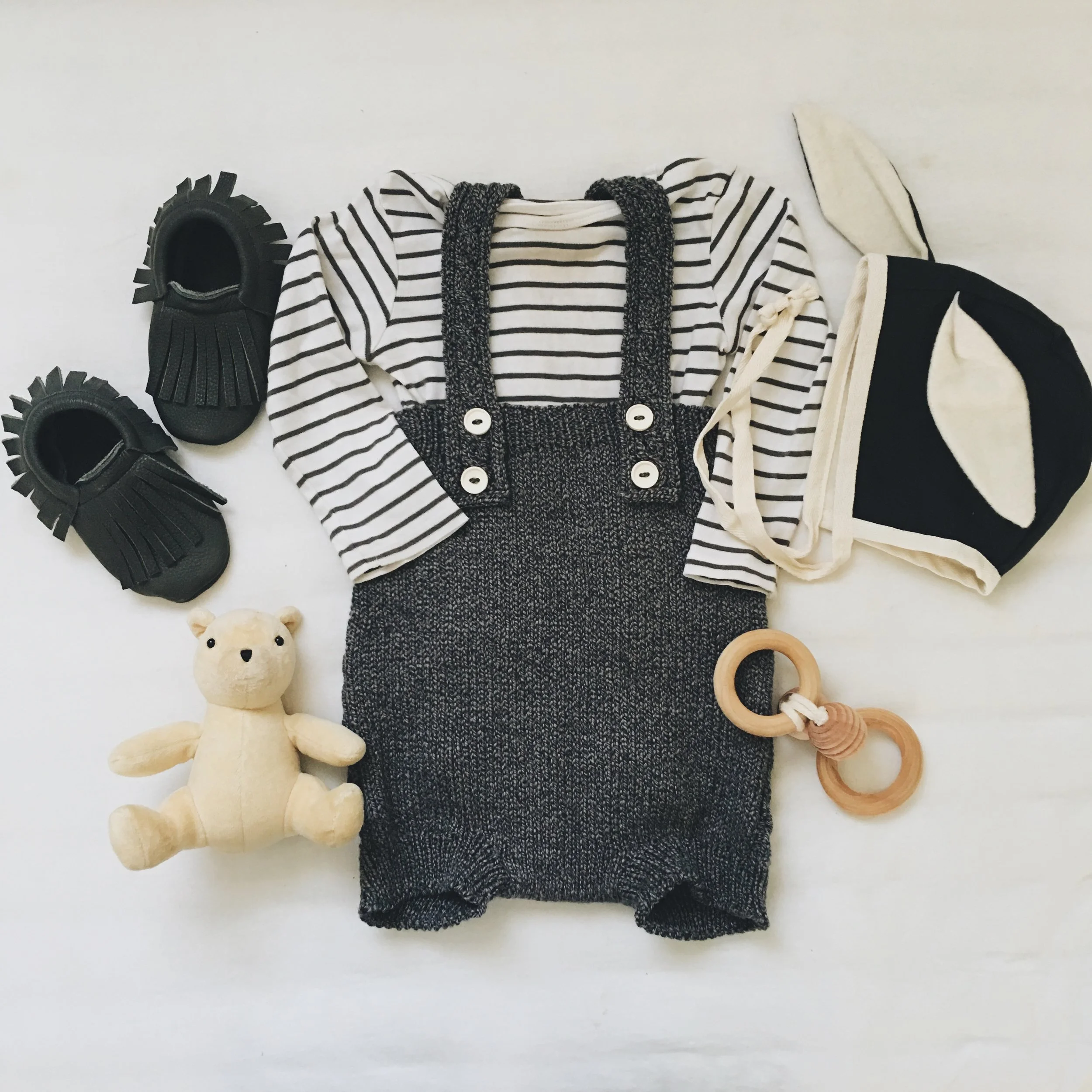 Knit Romper c/o Rainer & Bear ; Long Sleeve Onesie - H&M ; Rabbit-Eared Cap c/o Tortoise and The Hare Clothing ; Raven Moccasins c/o Little Pine Outfitters ; Bee Teether c/o Wild Creek Co