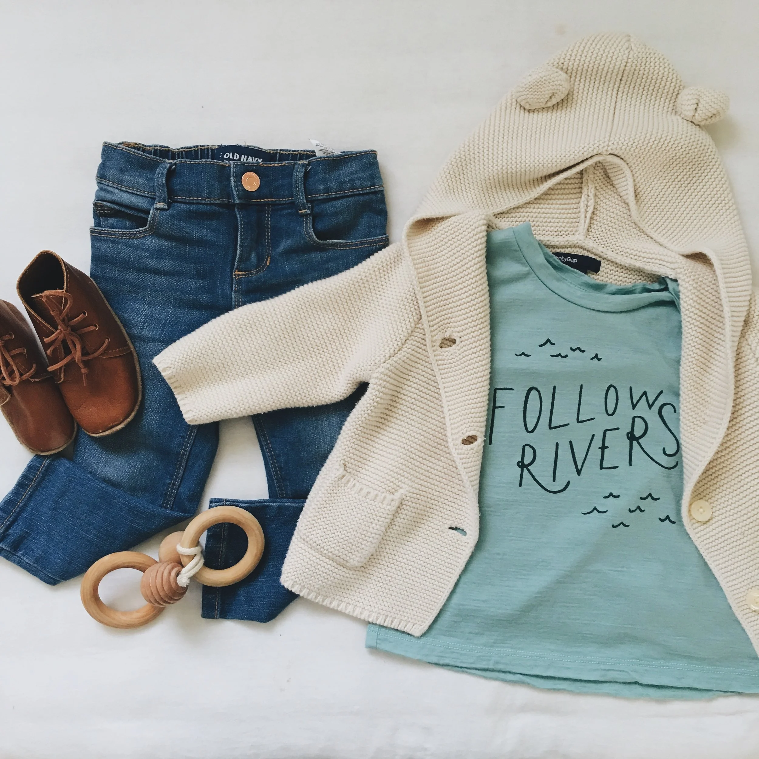 "Follow Rivers" Tee c/o Chasing Windmills ; Sweater - Gap; Jeans - Old Navy (girl's department) ; Leather Booties c/o Ulla + Viggo ; Bee Teether c/o Wild Creek Co