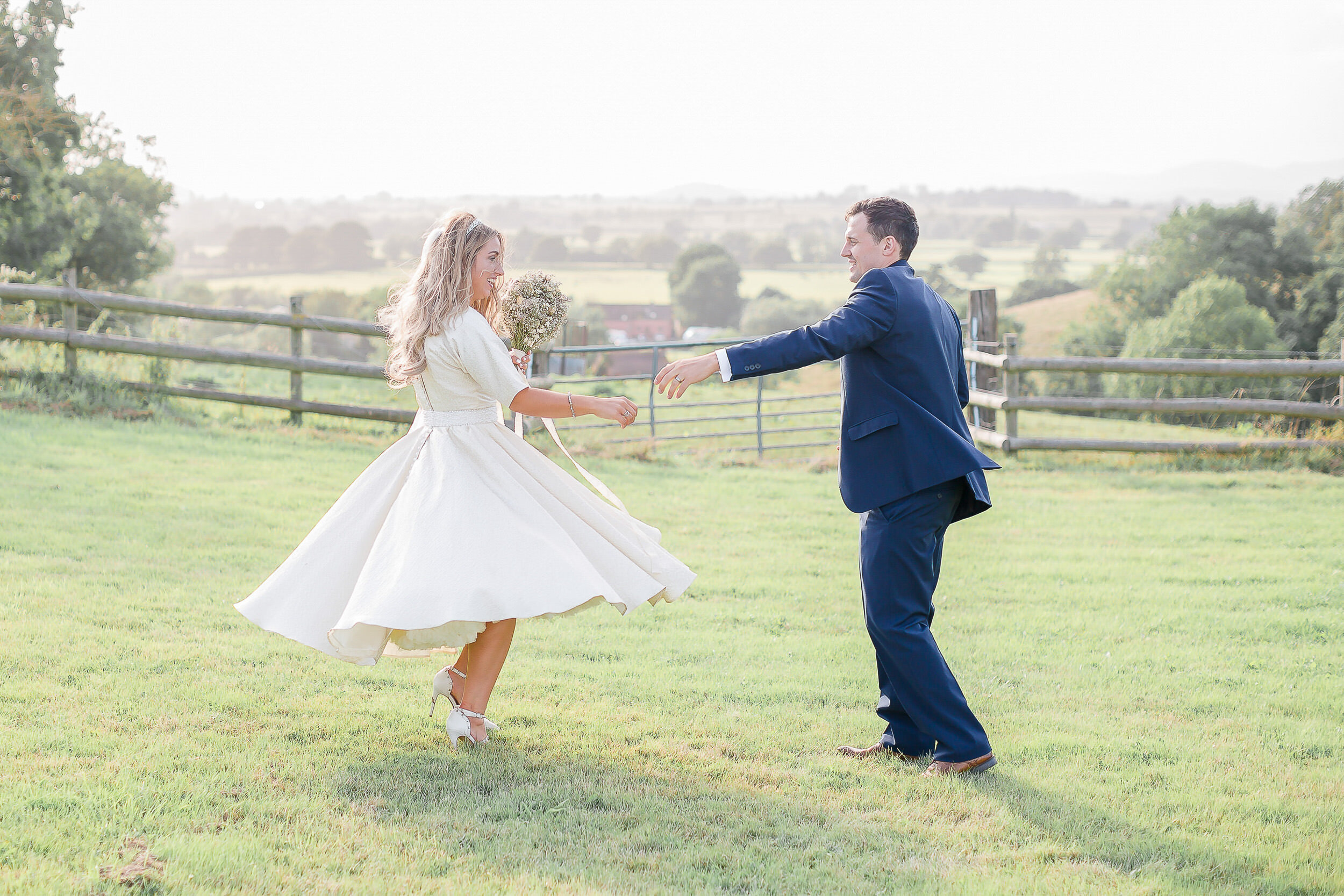 bride-groom-dancing-in-field.jpg
