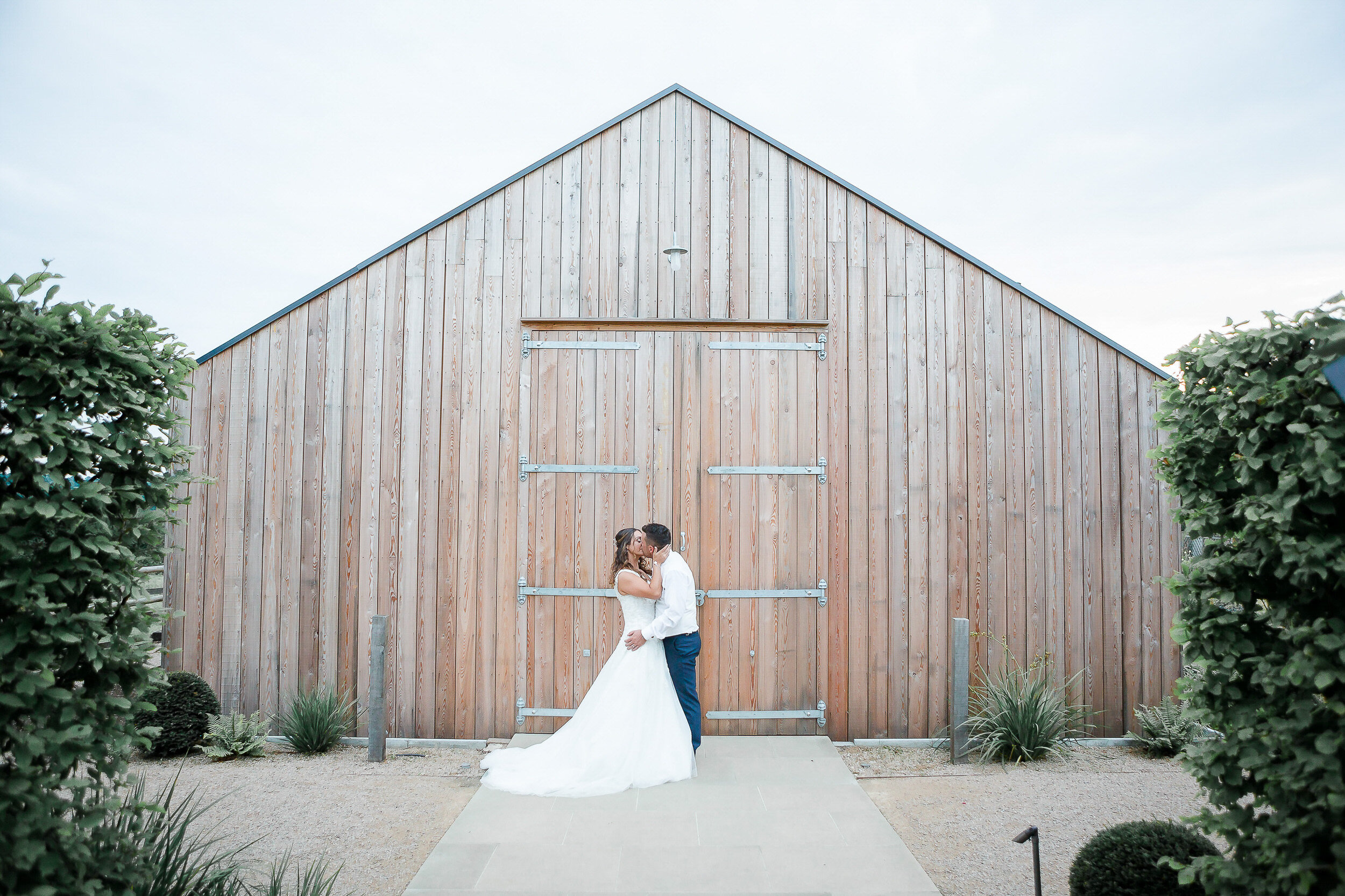 bride-groom-kissing-hyde-house-cotwolds.jpg