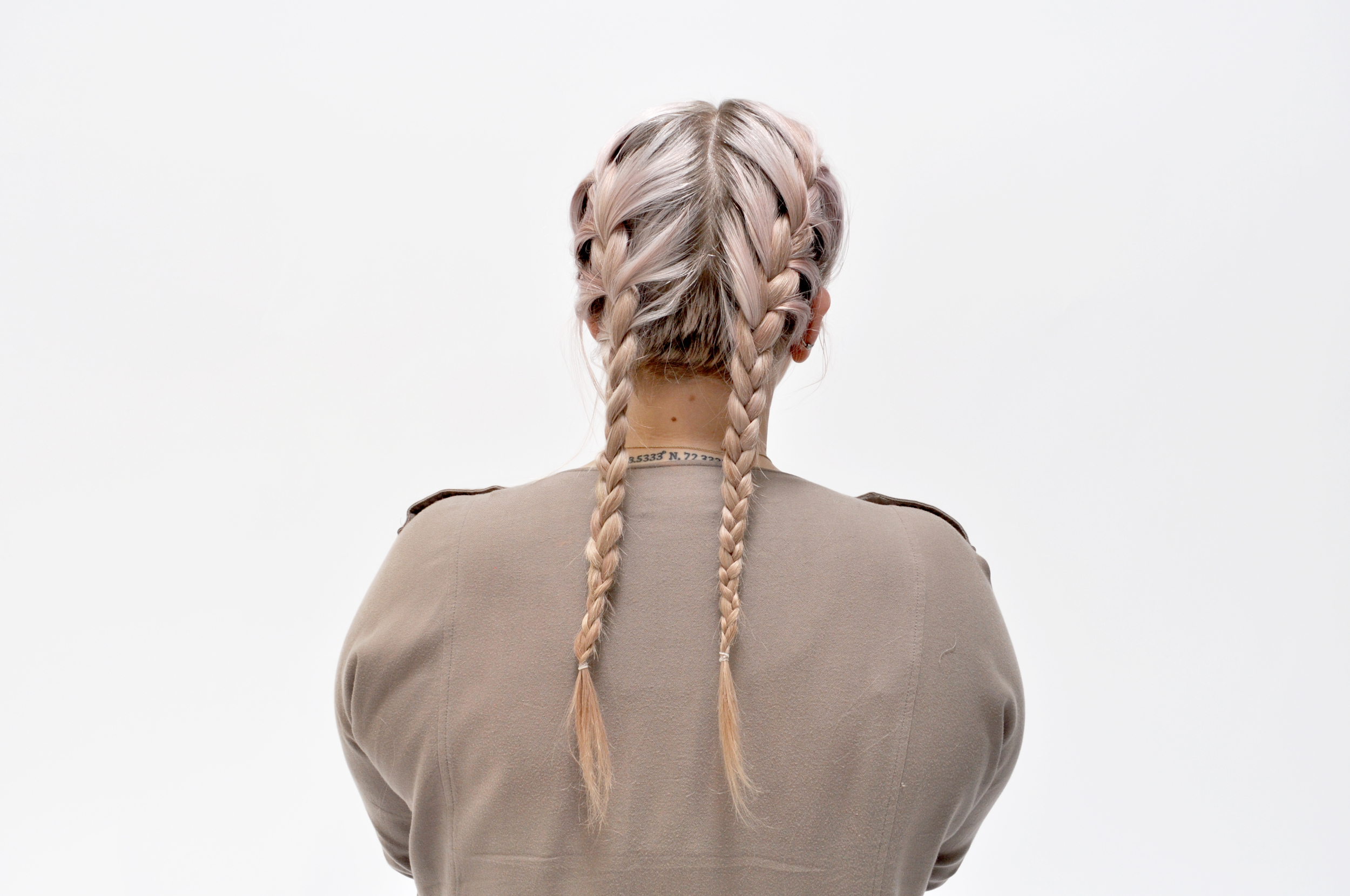  Once you have finished braiding on your head, finish the braid and tie it off with an elastic.&nbsp;Repeat on the opposite site, and TA-DA! You're a braid babe.&nbsp; 