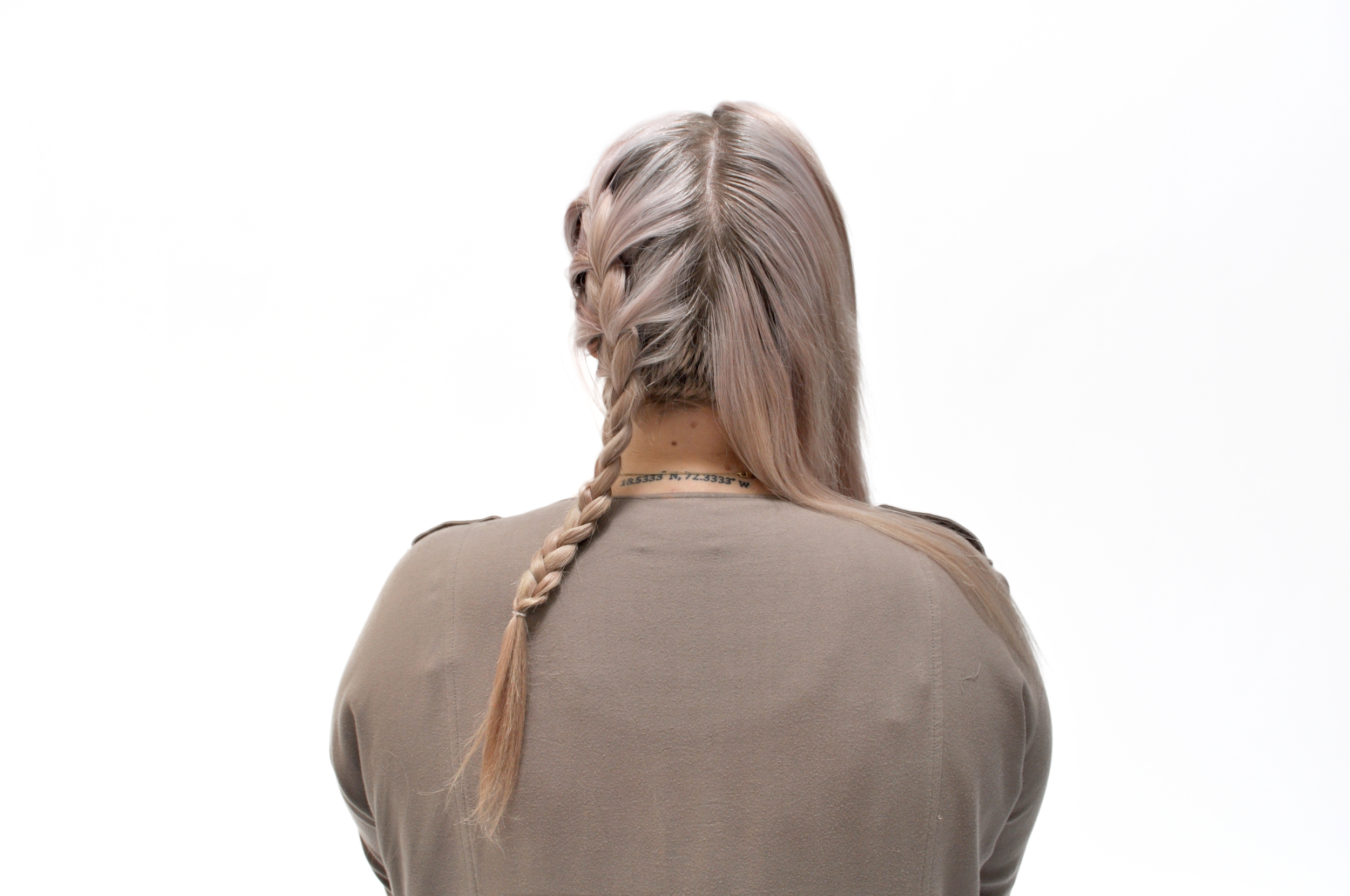  Start braiding. As you switch the strands from side to side, gather small sections from your head into the strands you have braided as you go down, making sure to keep them tight and neat. 