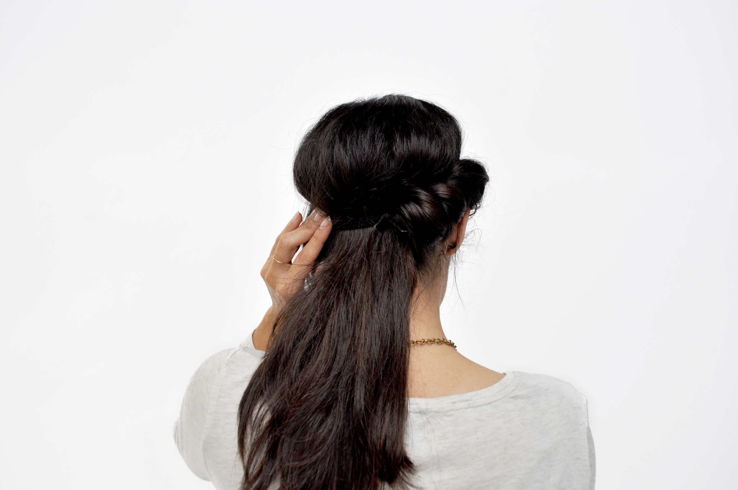  On one side of your hair, start tucking in your hair through the headband, and continue rolling until you get to the end. Repeat on the other side. 