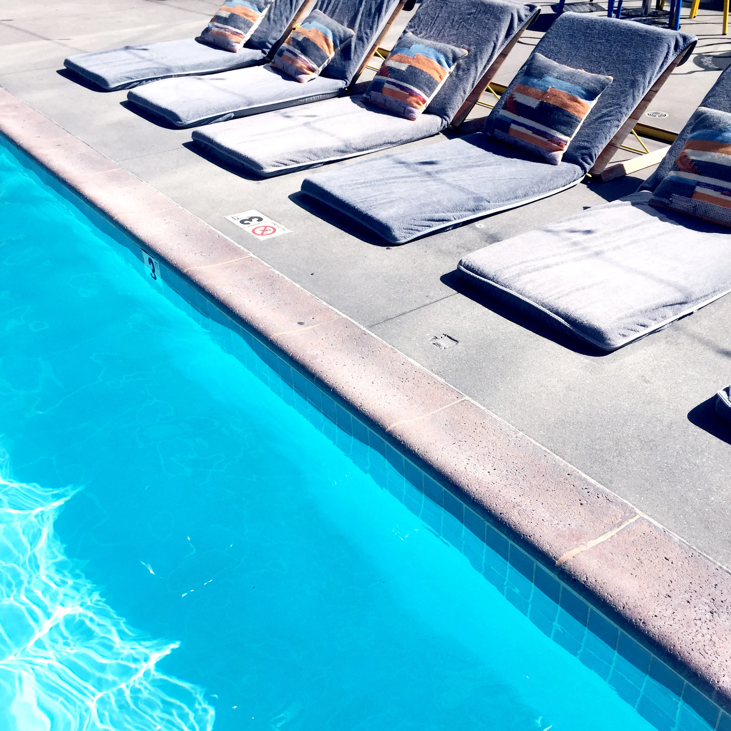 On your favorite floatie you'll have views of the CA sun, the city, and The LINE's distinct brutalist artchitecture. Credit: Kode of Kondukt