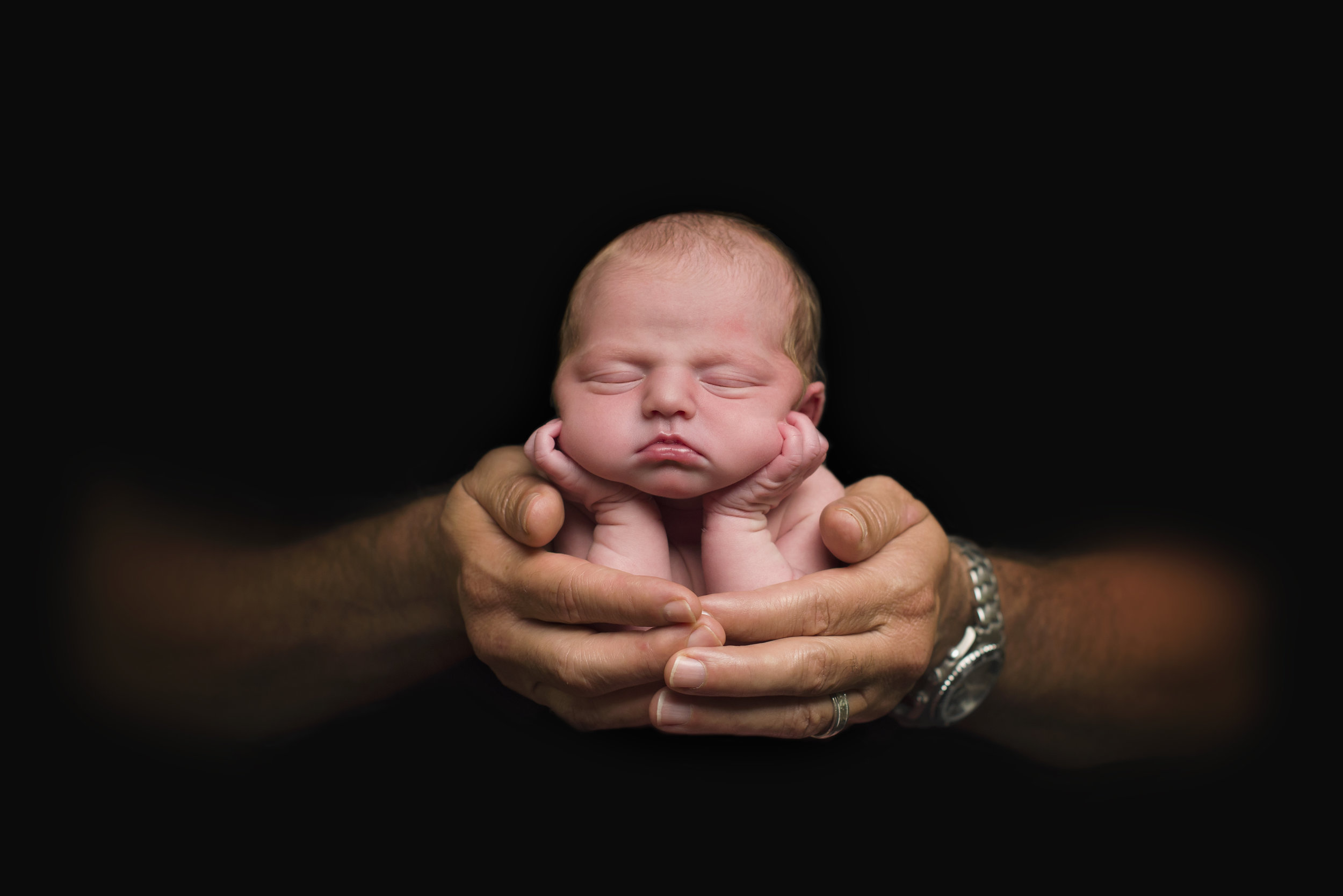 baby in daddys hands