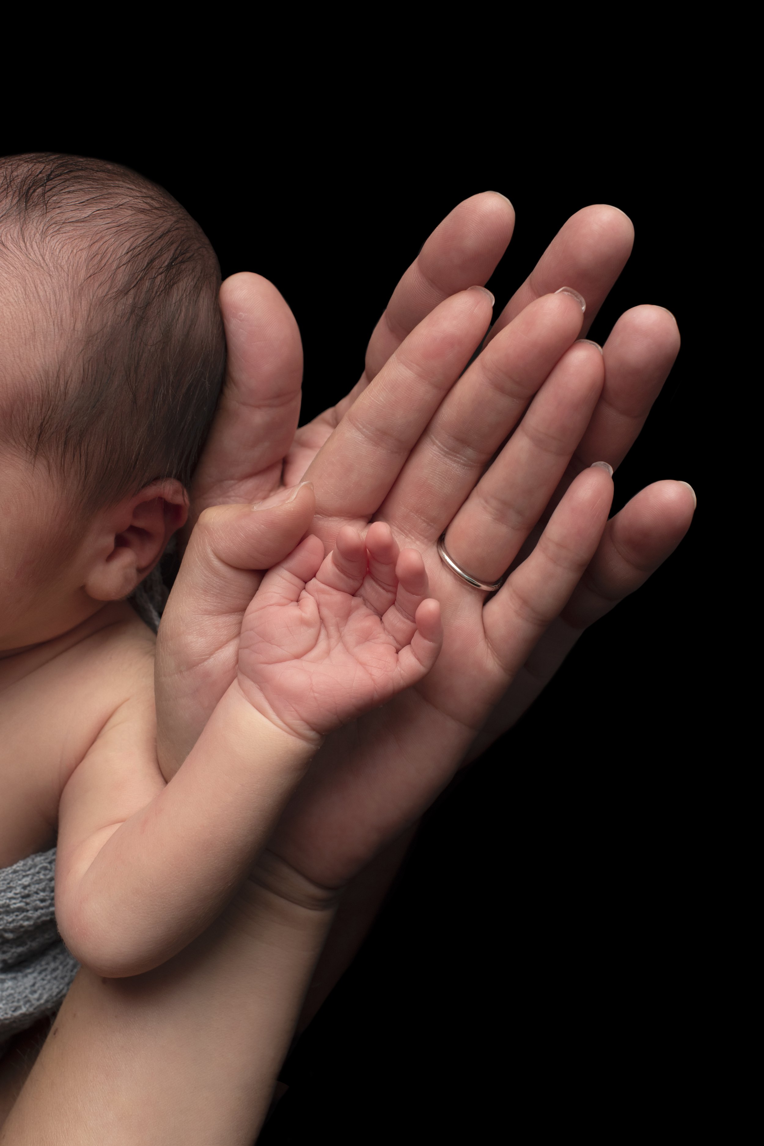 newborn baby family hands
