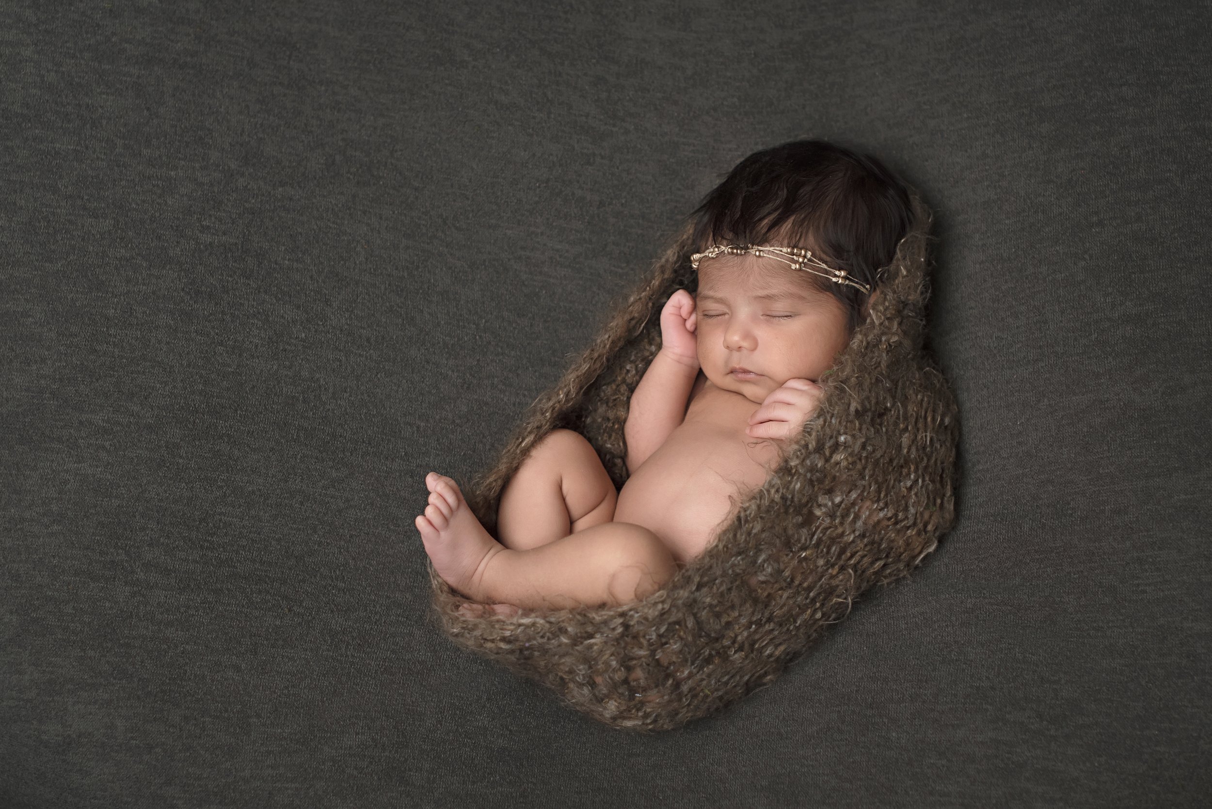 ethnic newborn baby wrapped in cocoon 