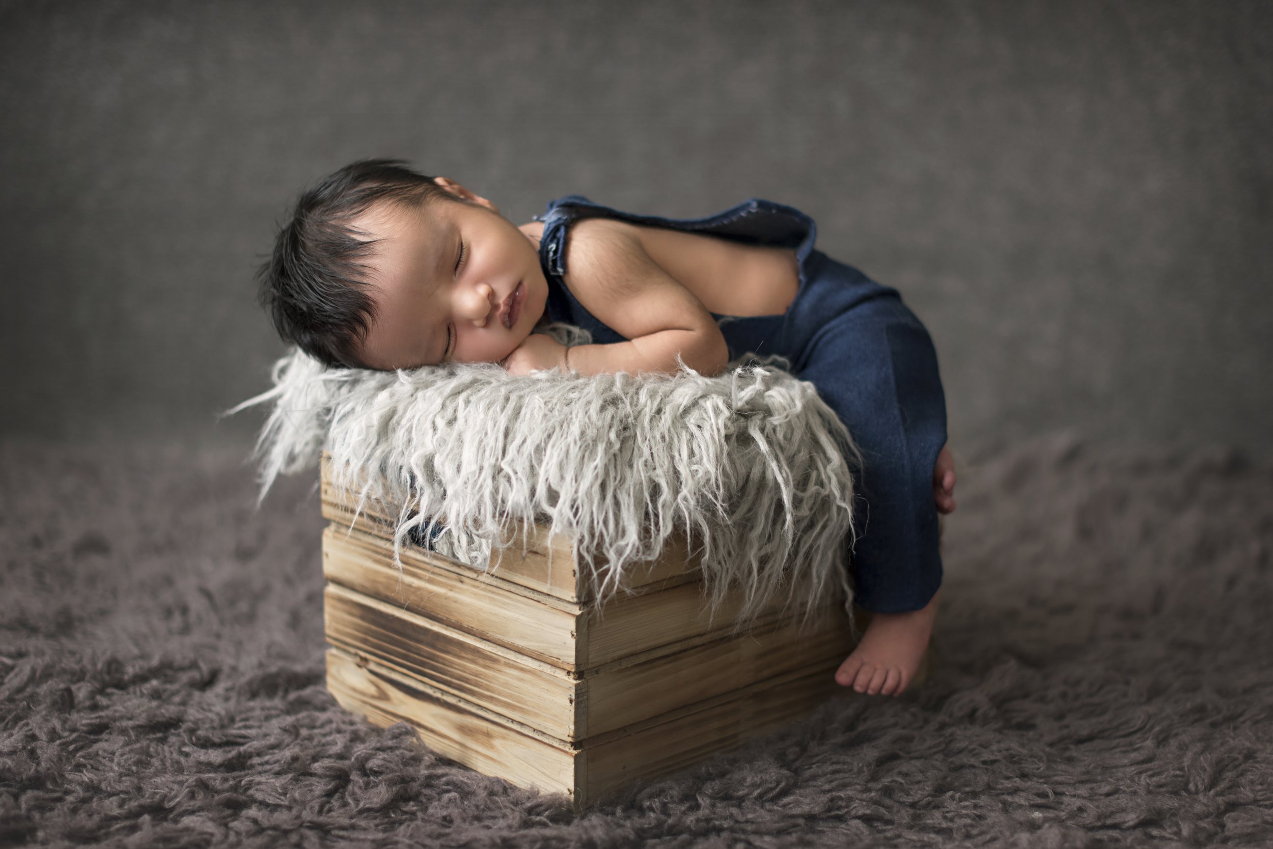 newborn boy in handmade overalls
