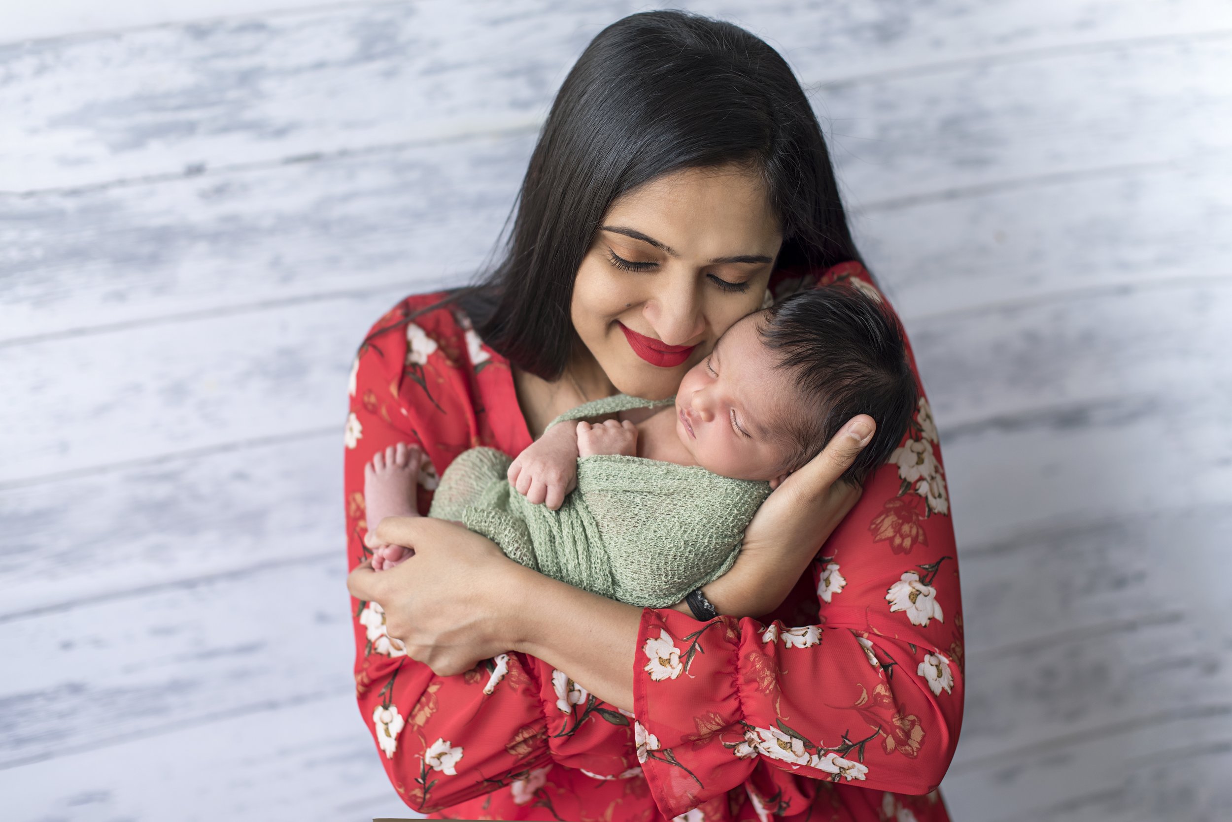 proud mommy holding newborn