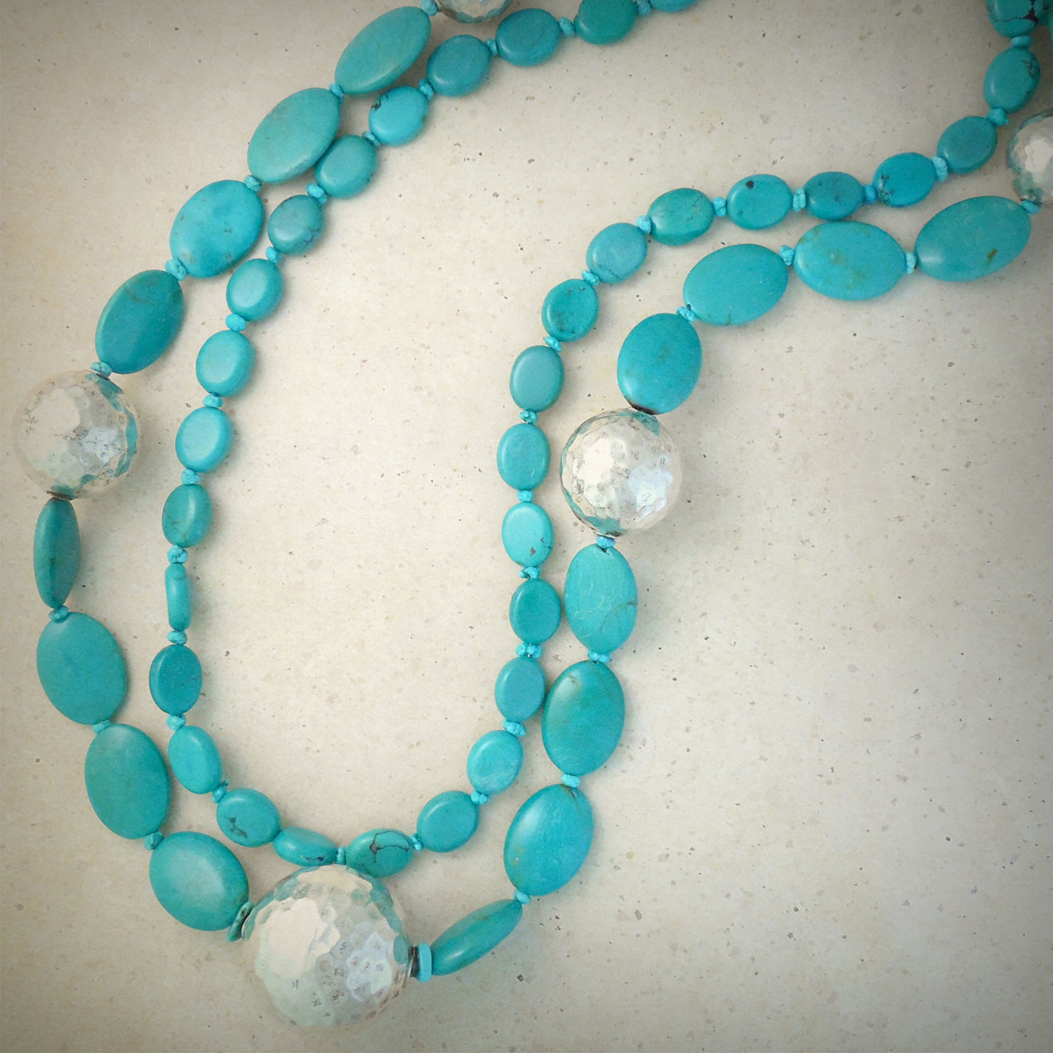 Oval turquoise beads with textured silver accents