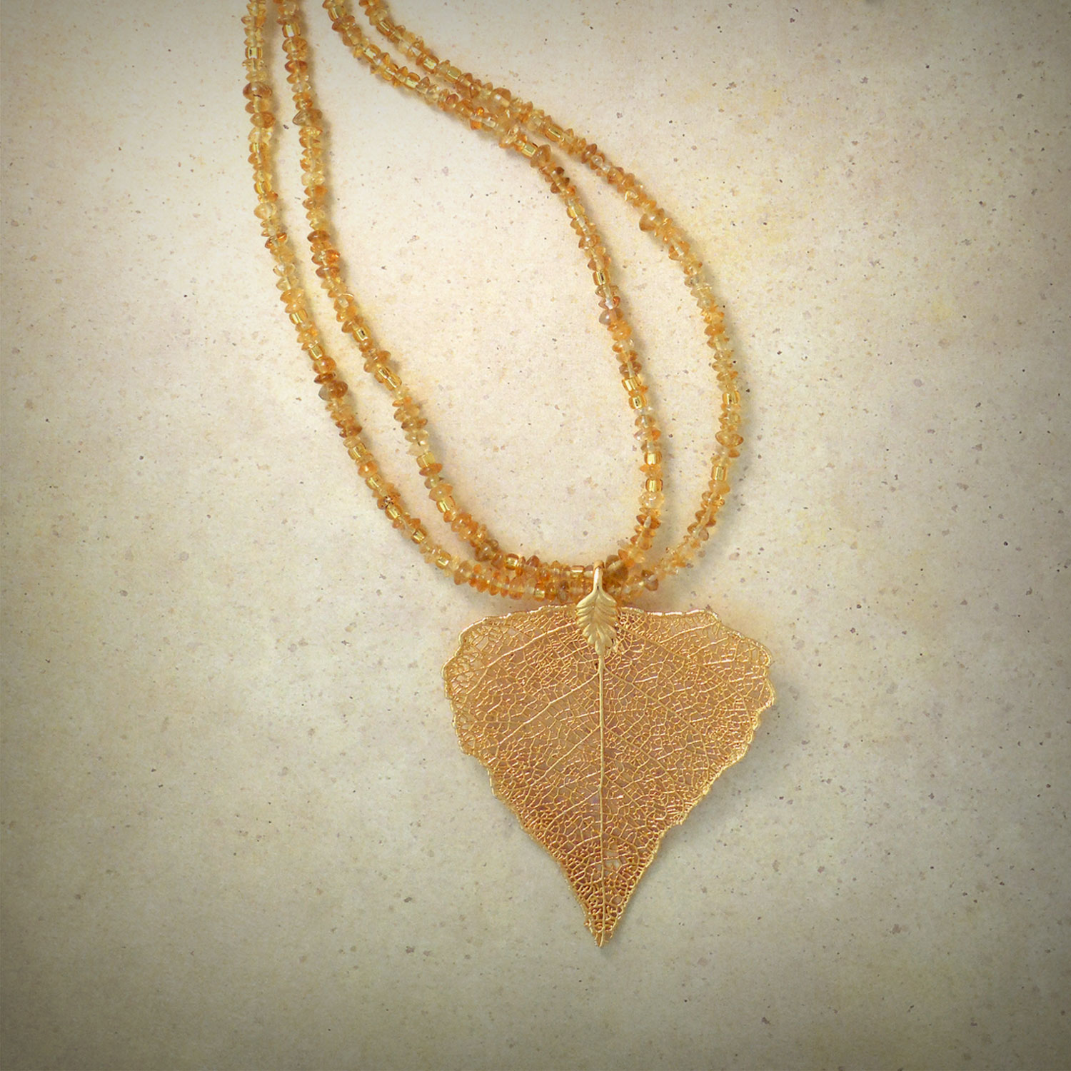 Gingko leaf dipped in liquid gold strung on a double strand of gold citrine beads
