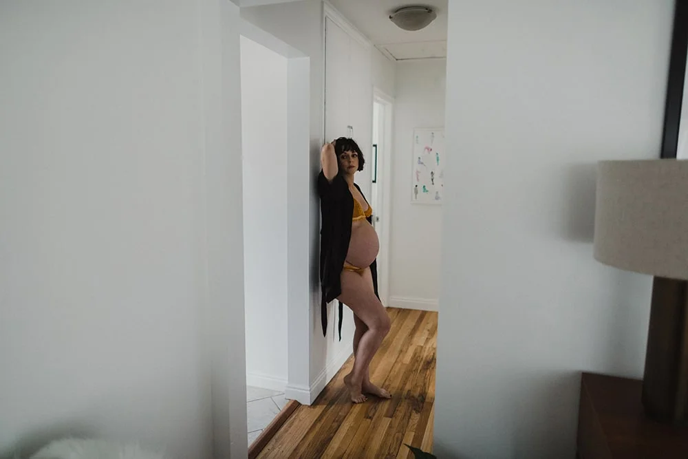 pregnant woman relaxing in black robe