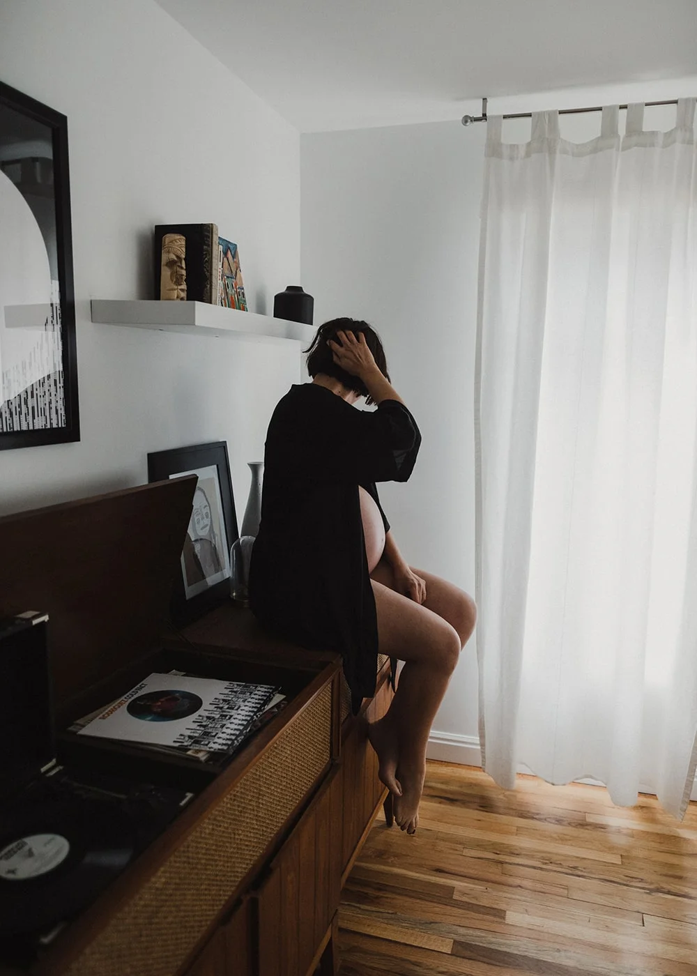 woman with record player sitting on edge