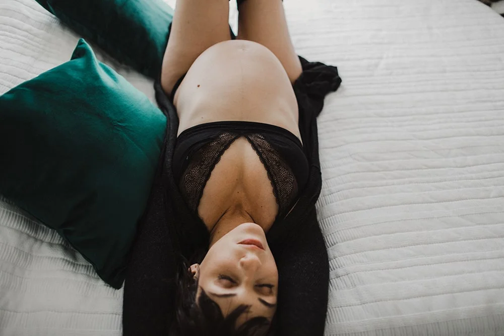 pregnant woman on bed in lingerie