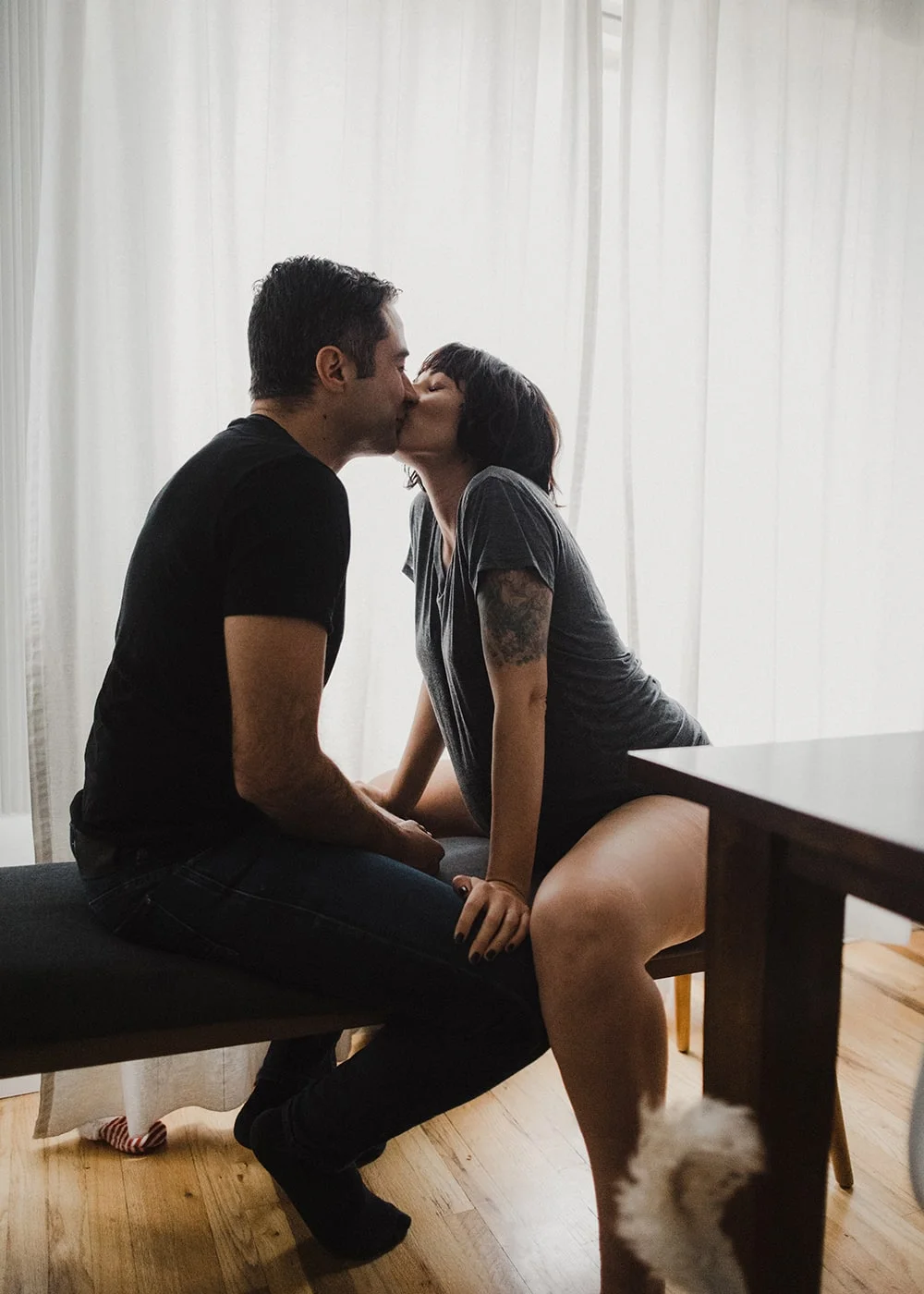 couple kissing with hands touching