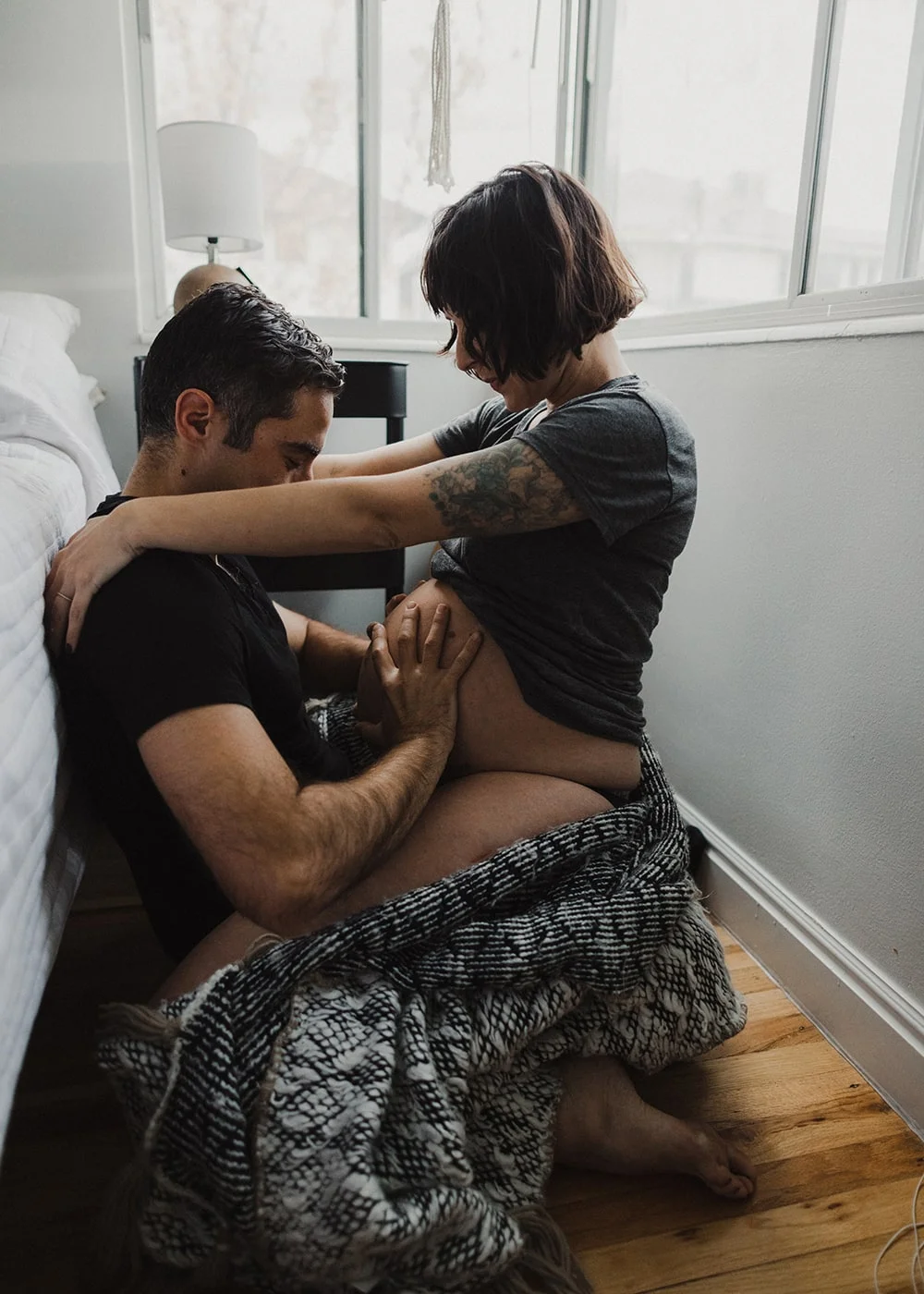 husband grabbing wife's pregnant stomach