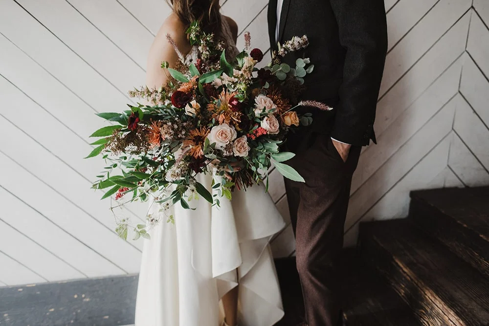 bridal bouquet in bride's hand and wedding dress