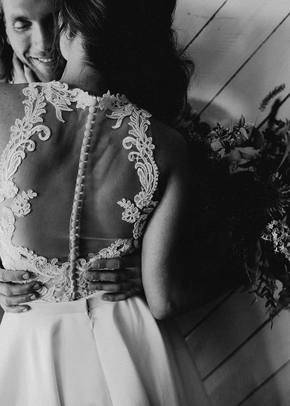 black and white of woman holding man's head