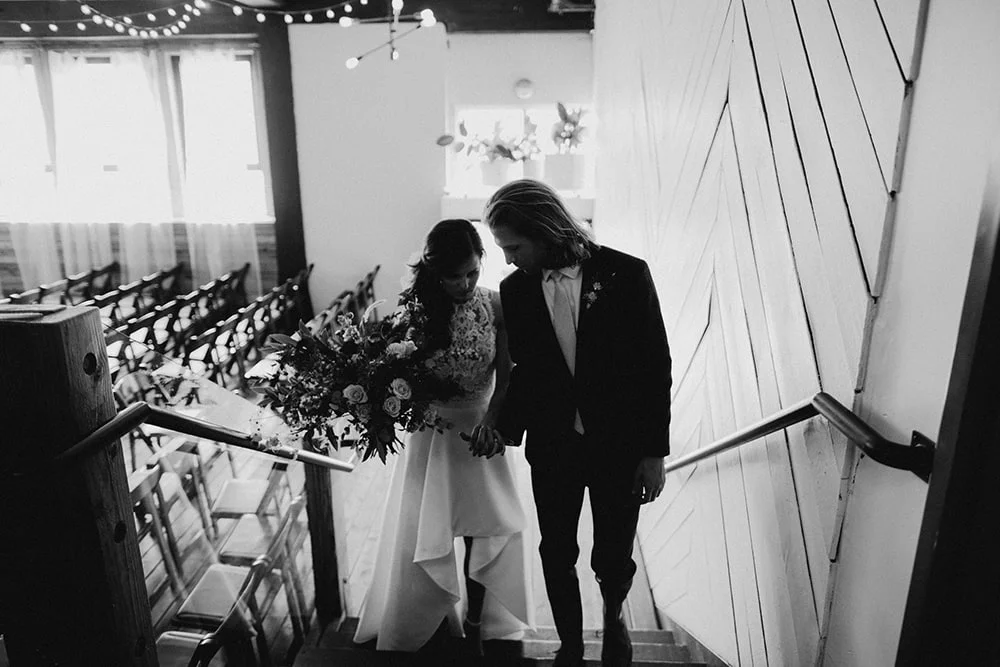 bride and groom walking up stairs before ceremony