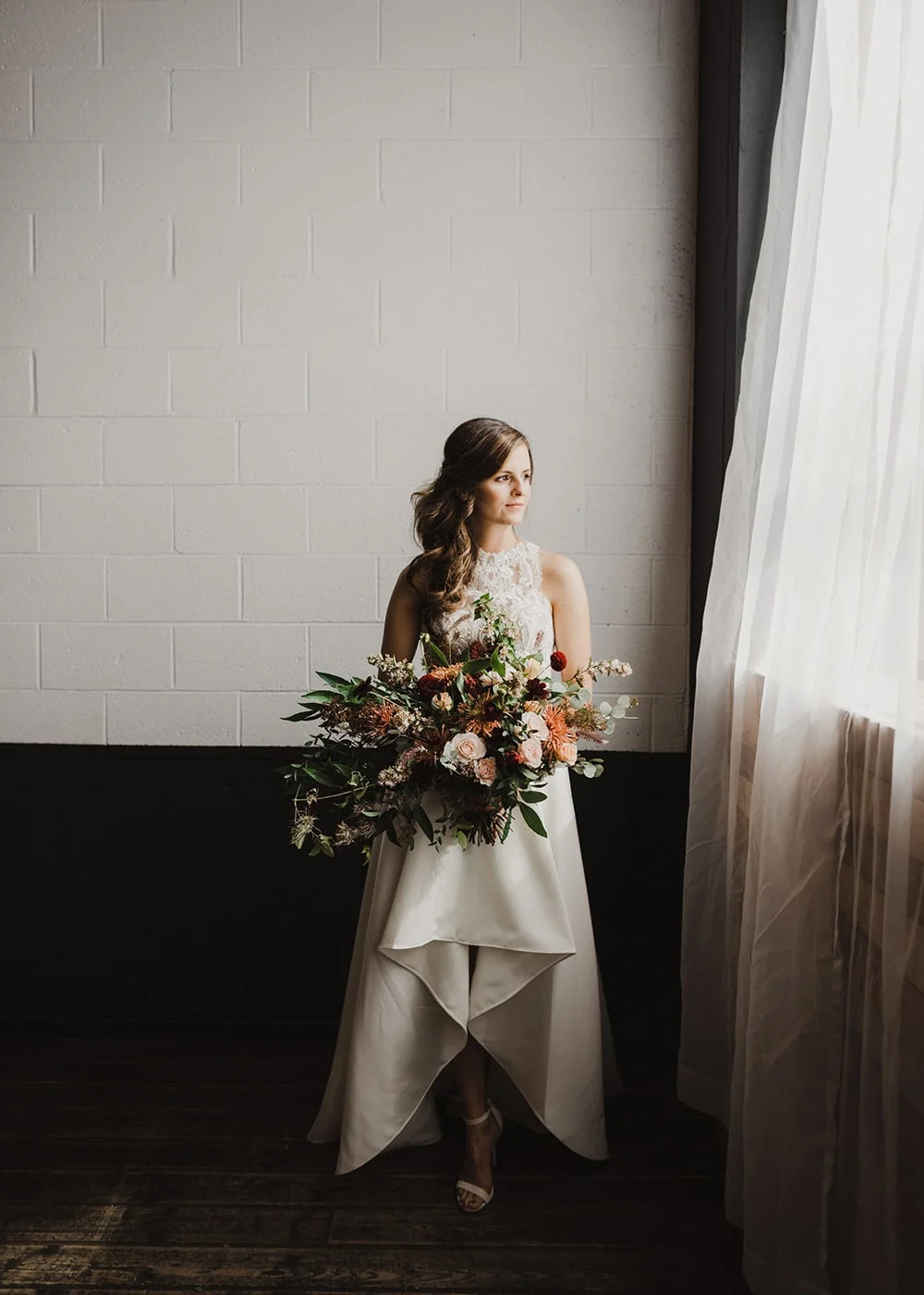 bride staring out window with relaxed expression