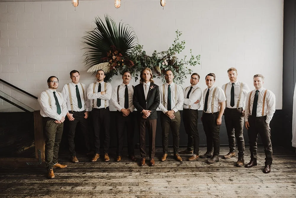 groom and groomsmen holding hands at waist