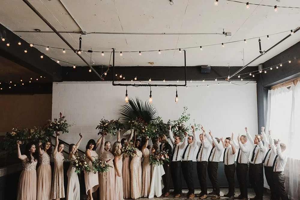 bridesmaids and groomsmen celebrating for photographer