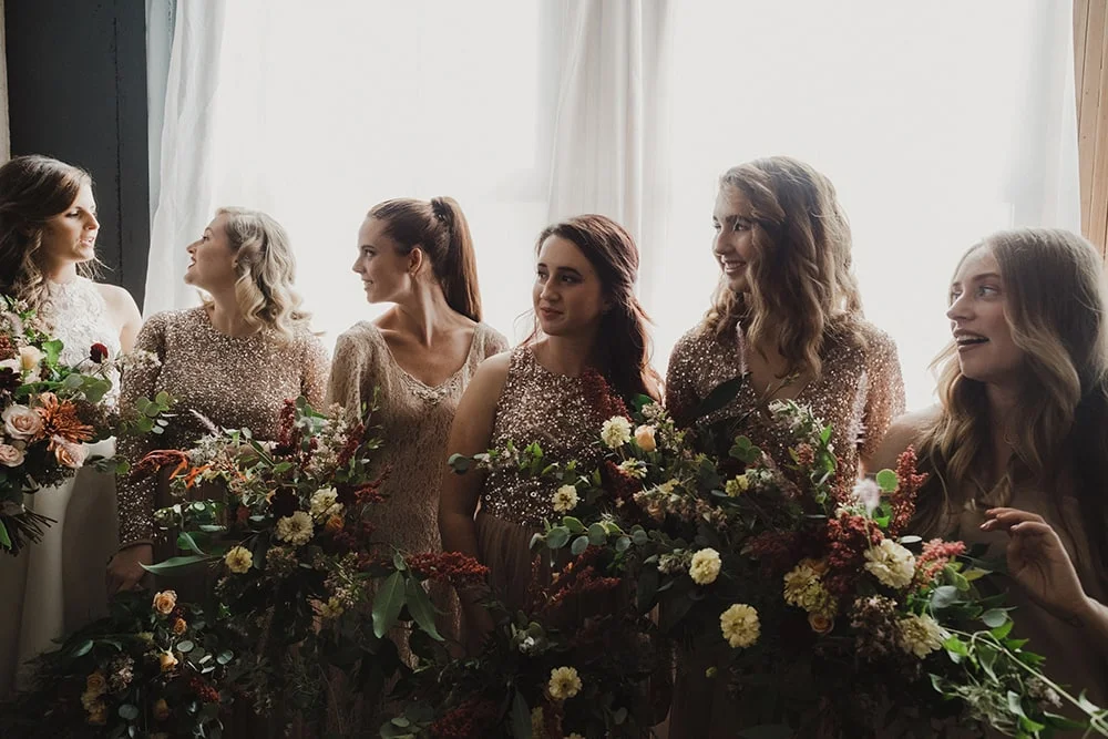 bridesmaids looking at bride with sweet faces
