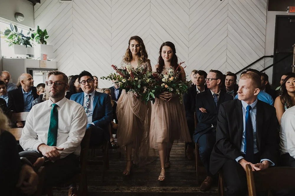 bridesmaids walking in sync down isle