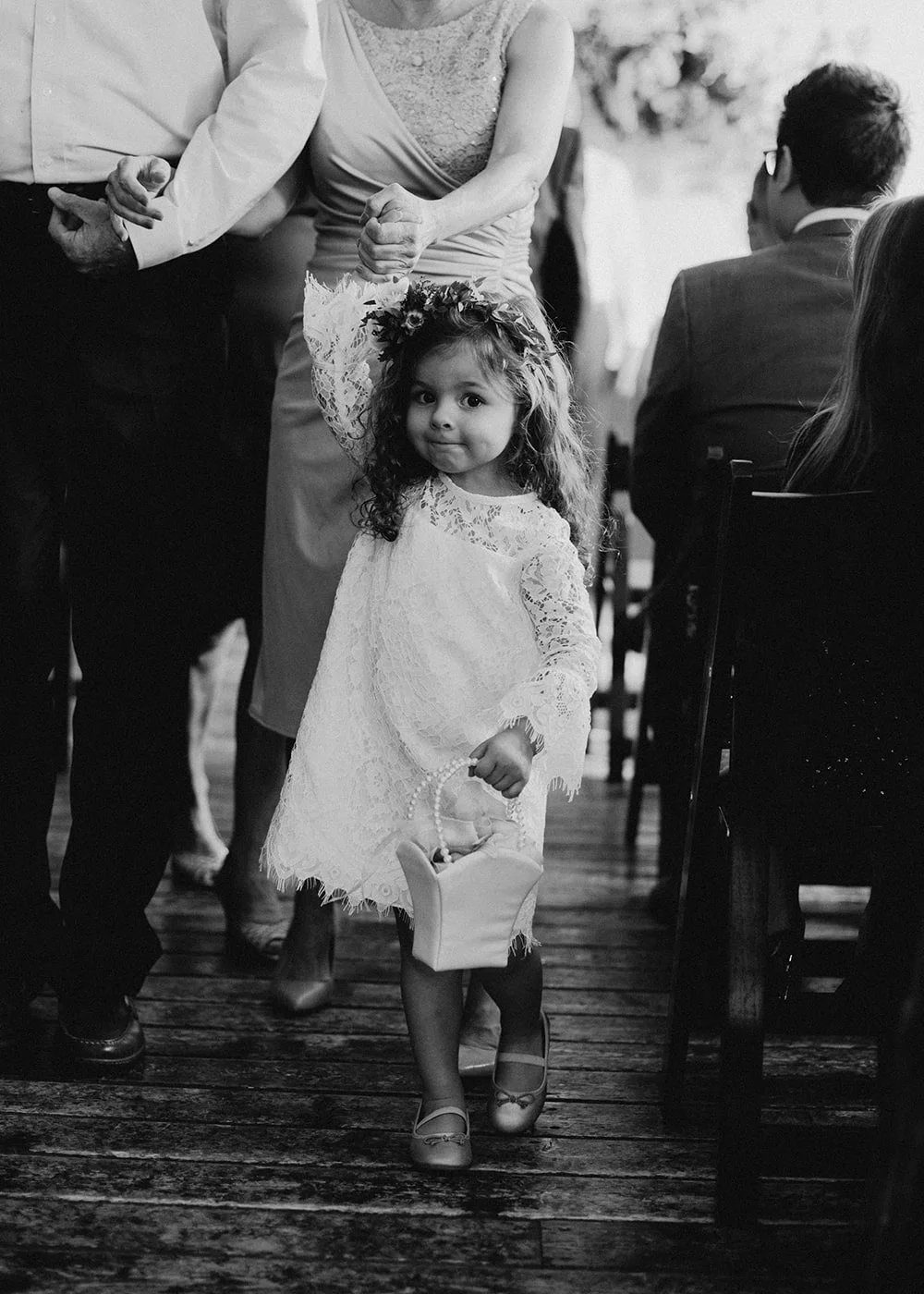 flower girl looking at camera walking down isle