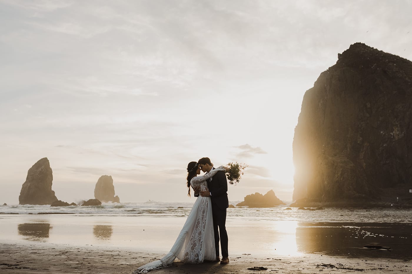 couple kissing on cannon beach before wedding ceremony and elopement