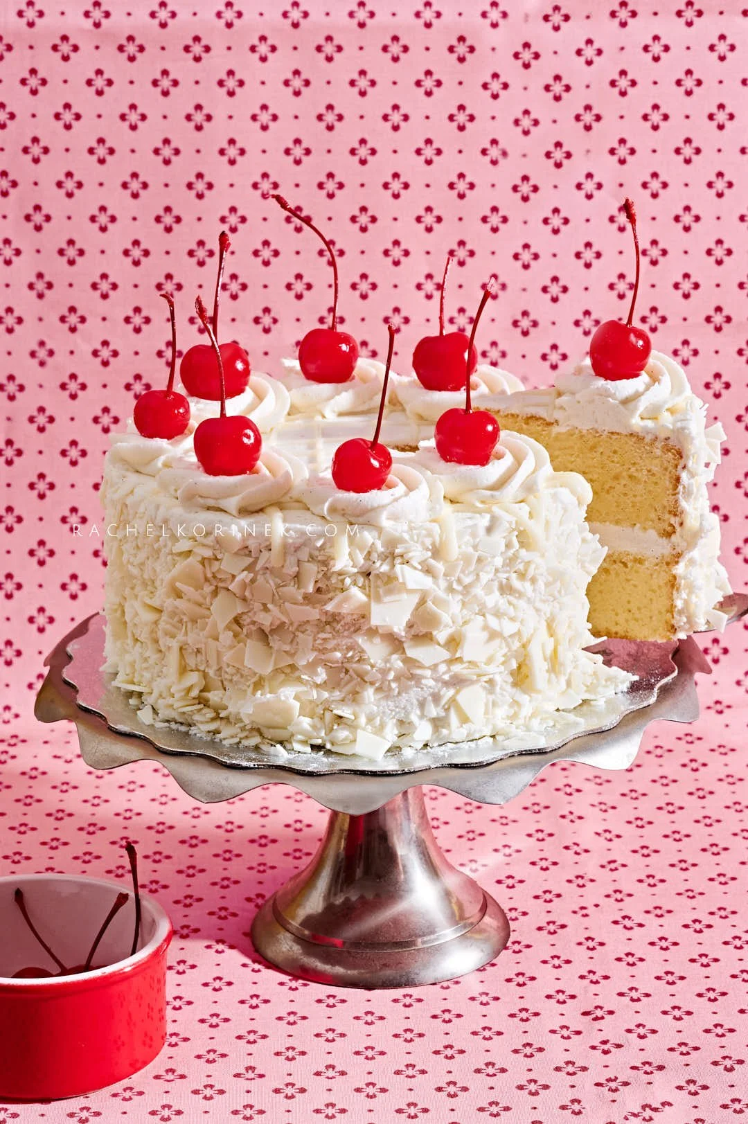  white grocery-store cake on a pink fabric. 